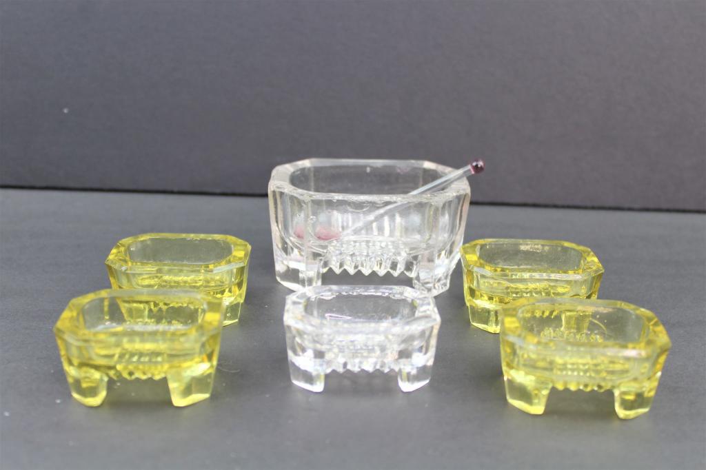 6 Square Crystal Yellow and Clear Salt Cellars: Lot of 6 Crystal Cellars with 1 Glass Spoon. 4 Smaller Cellars are a yellow tone and measure about 2"l x 1"T. Smaller Clear One Measures the same and the Large Clear Cellar measures about 3 1/4"l x 1.