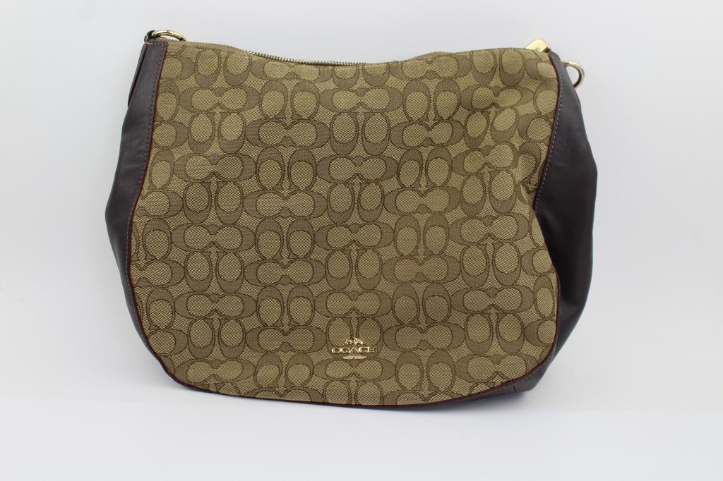 Brown and Tan Coach Monogram Purse Bag: Brown and Tan Coach Monogram Purse Bag . Has Dark brown Leather bottom with the classic Coach Monogram fabric on the sides. Good Overall condition. Measures about 12"w x 10.5"t Has Single Leather Hand