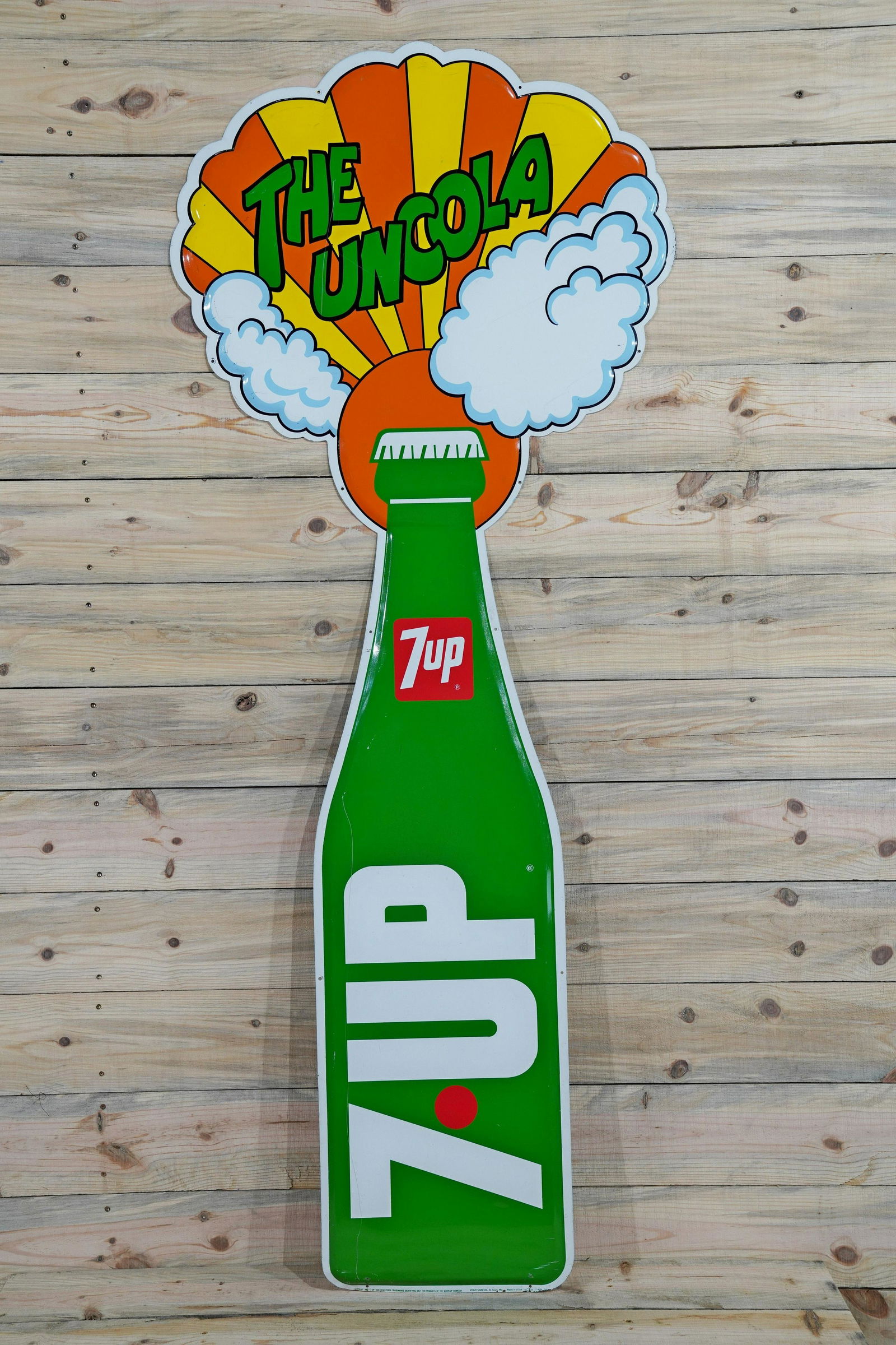 7up The Uncola Bottle SST Diecut Metal Sign TAC 8.75: 7up The Uncola Bottle Single Sided Tin Diecut Vertical Metal Sign. Good color and shine with light wear and fine scratches in lower field. Marked Stout Sign Co, dated 1969. Measures 71"x29". Rated 8.7