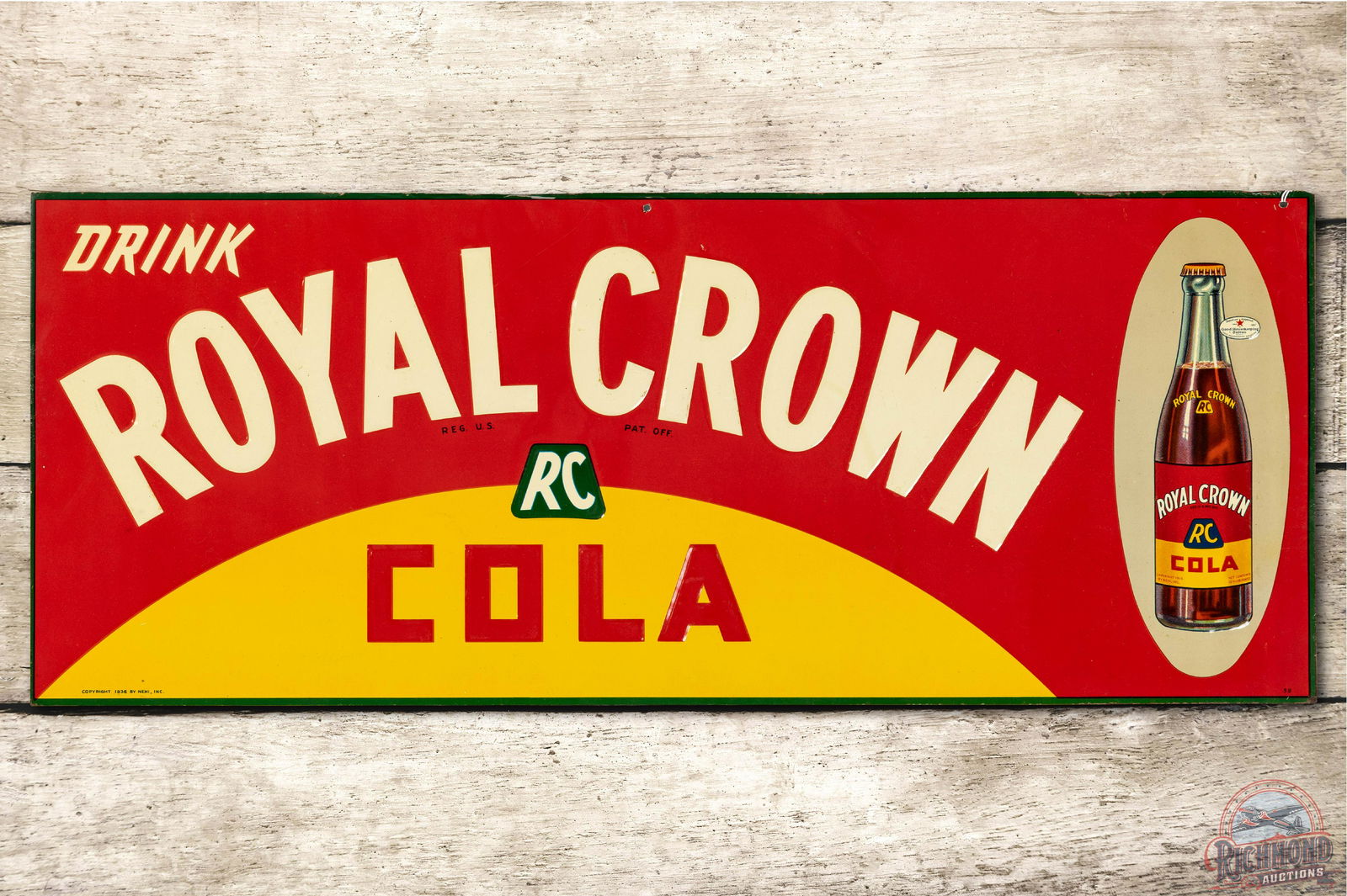 Drink Royal Crown RC Cola & Bottle Embossed Tin Sign: Single sided tin (SST) embossed sign has excellent color and shine. The field has minor nicks in the lettering and a small hit above the Crown. The sign has some paper staining throughout with small s