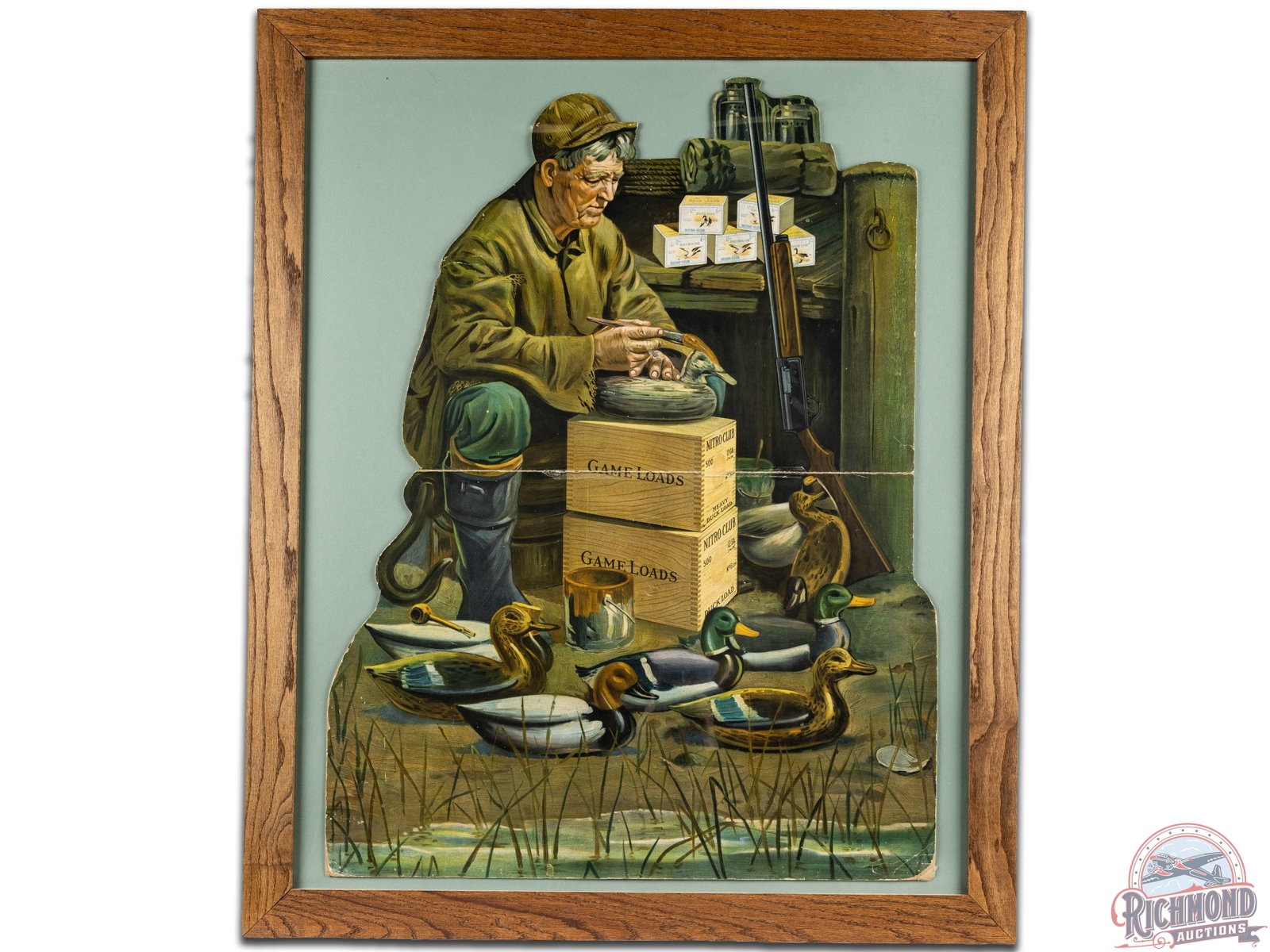 Remington UMC Nitro Club Duck Loads Die Cut Cardboard Store Display Sign: Wonderful Remington UMC duck loads die cut cardboard store display in a newer frame that displays very well. It has good color with a fantastic scene of a man painting decoys. It shows some wear, hori