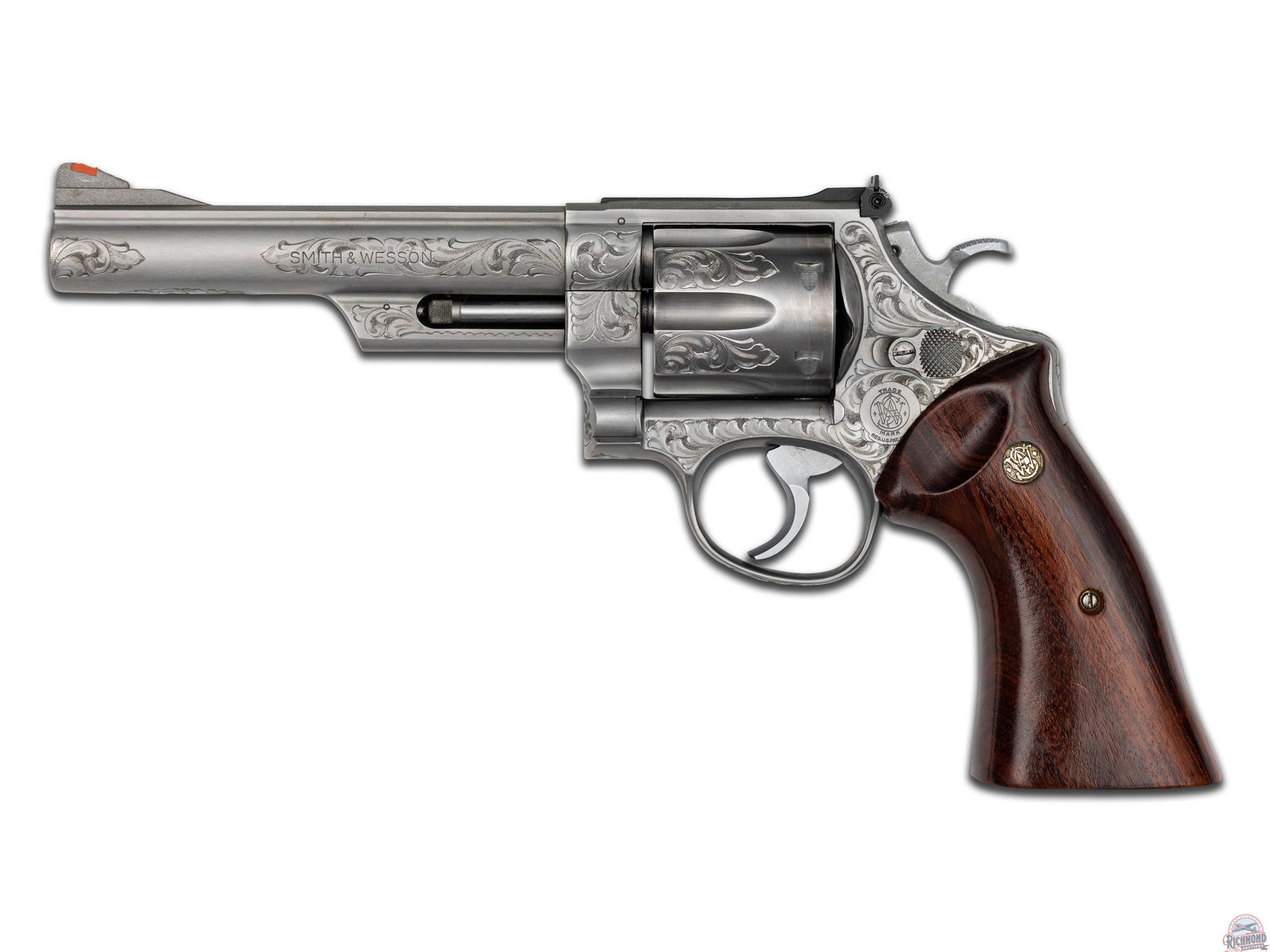 Factory Engraved Smith & Wesson Model 629 Double Action Revolver & Box: Manufactured in 1980 with standard markings on the barrel and frame. Pinned 6" barrel with ramped blade plastic insert front sight and standard adjustable rear. Six shot fluted cylinder. Factory stain