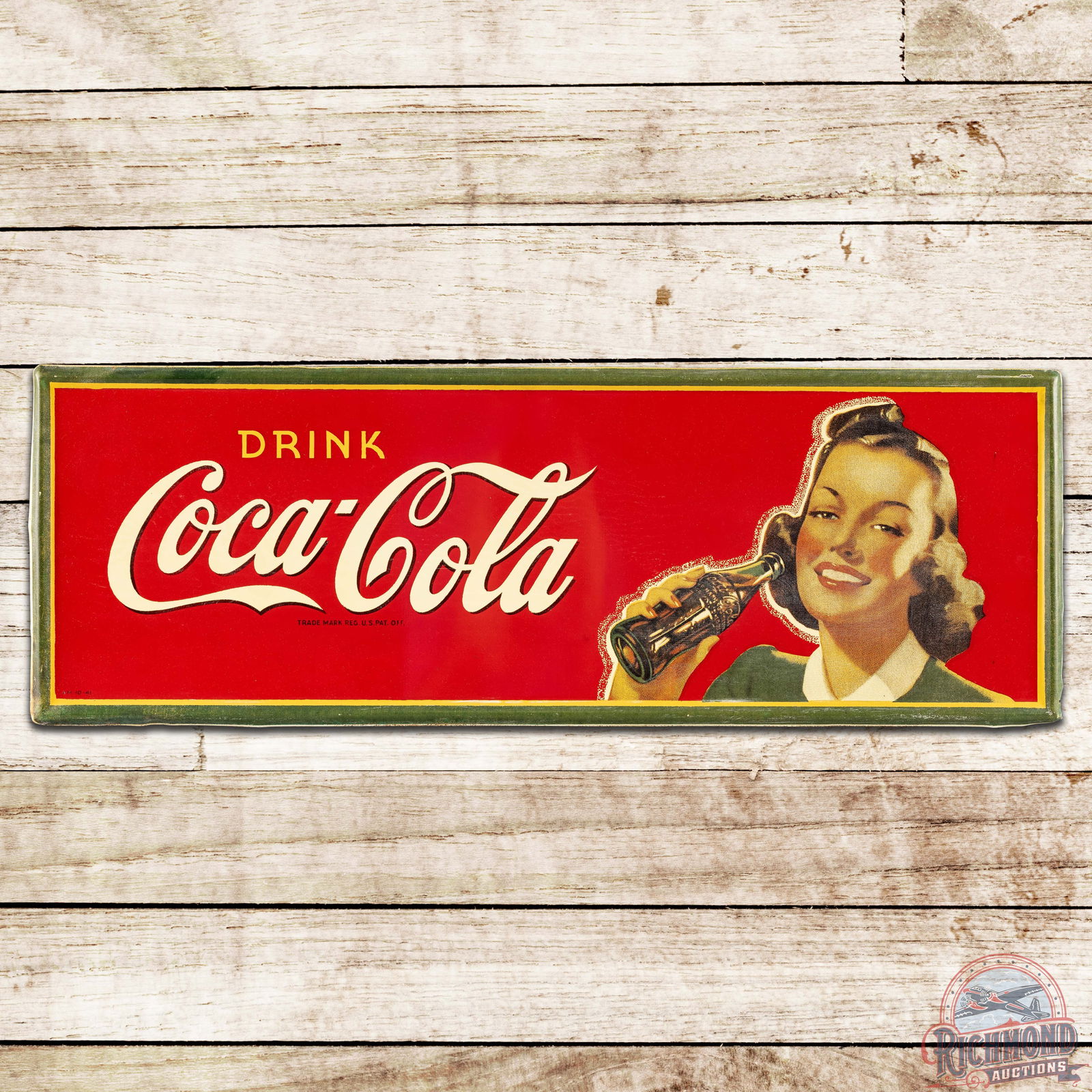 1941 Drink Coca-Cola SST Sign w/ Lady & Bottle: SST (single sided tin) self-framed Coke sign has excellent color and shine. The field is very clean overall with minor paper marks, a small dimple and minor toning. The perimeter is very clean as well