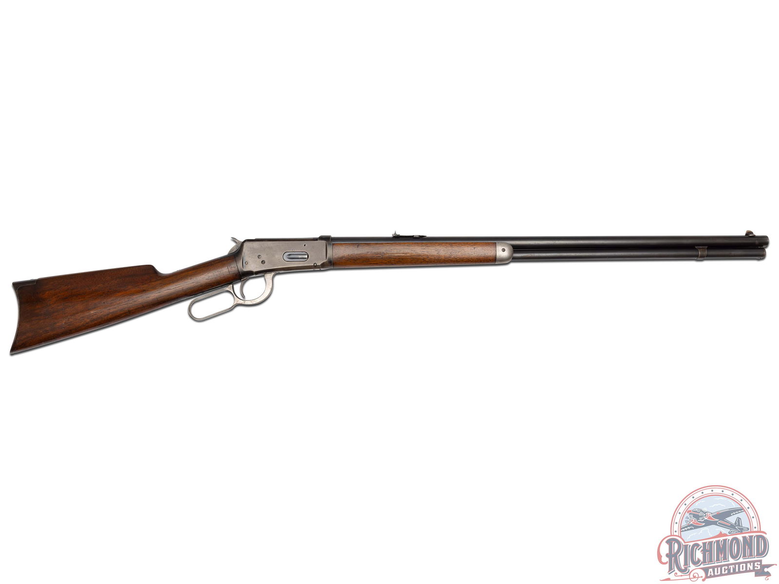 Winchester Model 1894 Lever Action Rifle in 25-35 W.R.F.: Made in 1909. 26" nickel steel barrel in 25-35 caliber with Lyman front and rear sights. Blued solid frame action with full magazine and plain trigger. Standard walnut stocks with crescent steel Butt