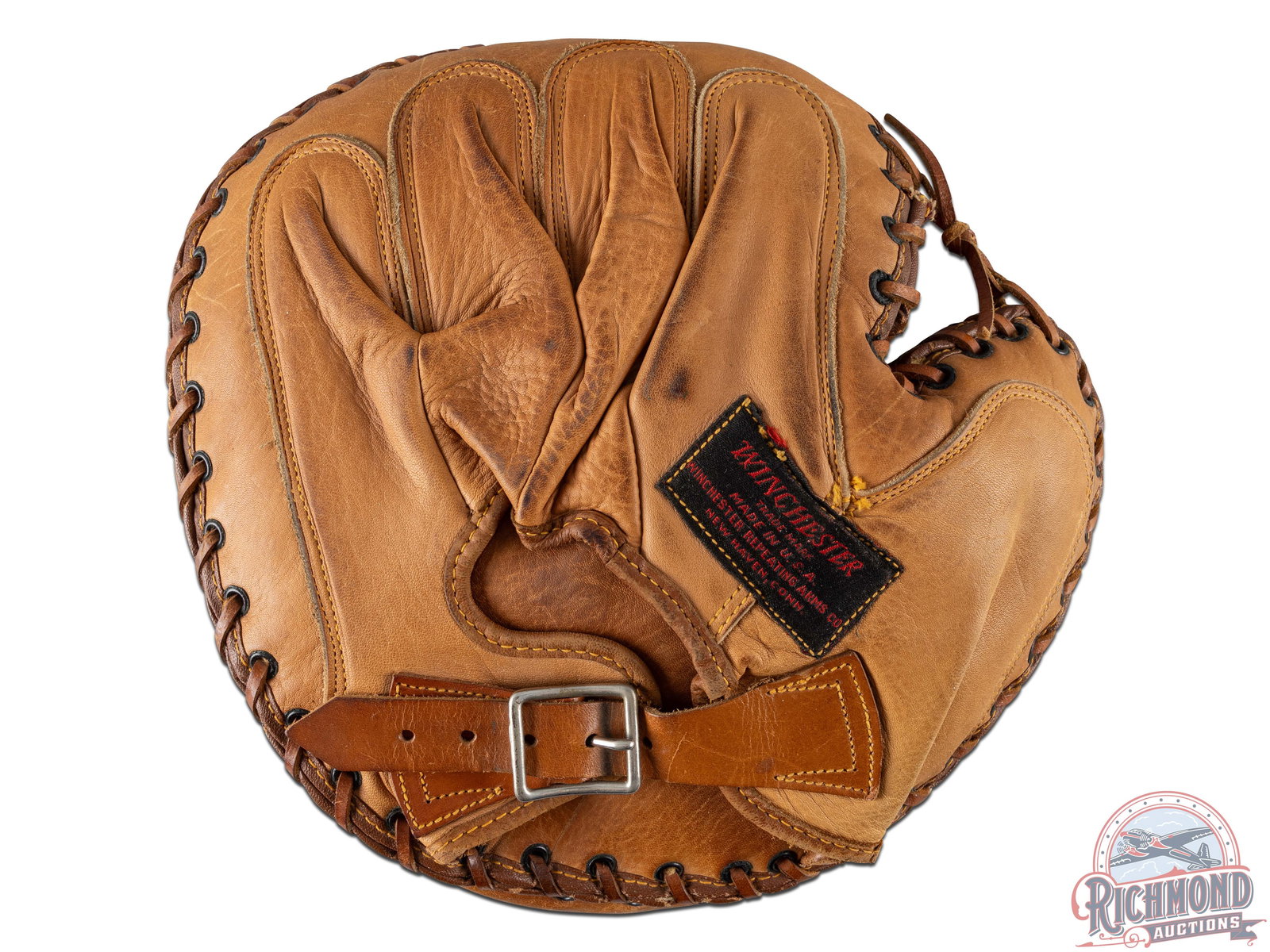 Winchester No. 2060 Leather Baseball Catchers Mitt: Original Winchester catchers mitt, with visible markings, model number 2060 and Winchester Diamond on the front. Retains Winchester tag on the reverse and intact adjustable wrist strap with buckle. Fu