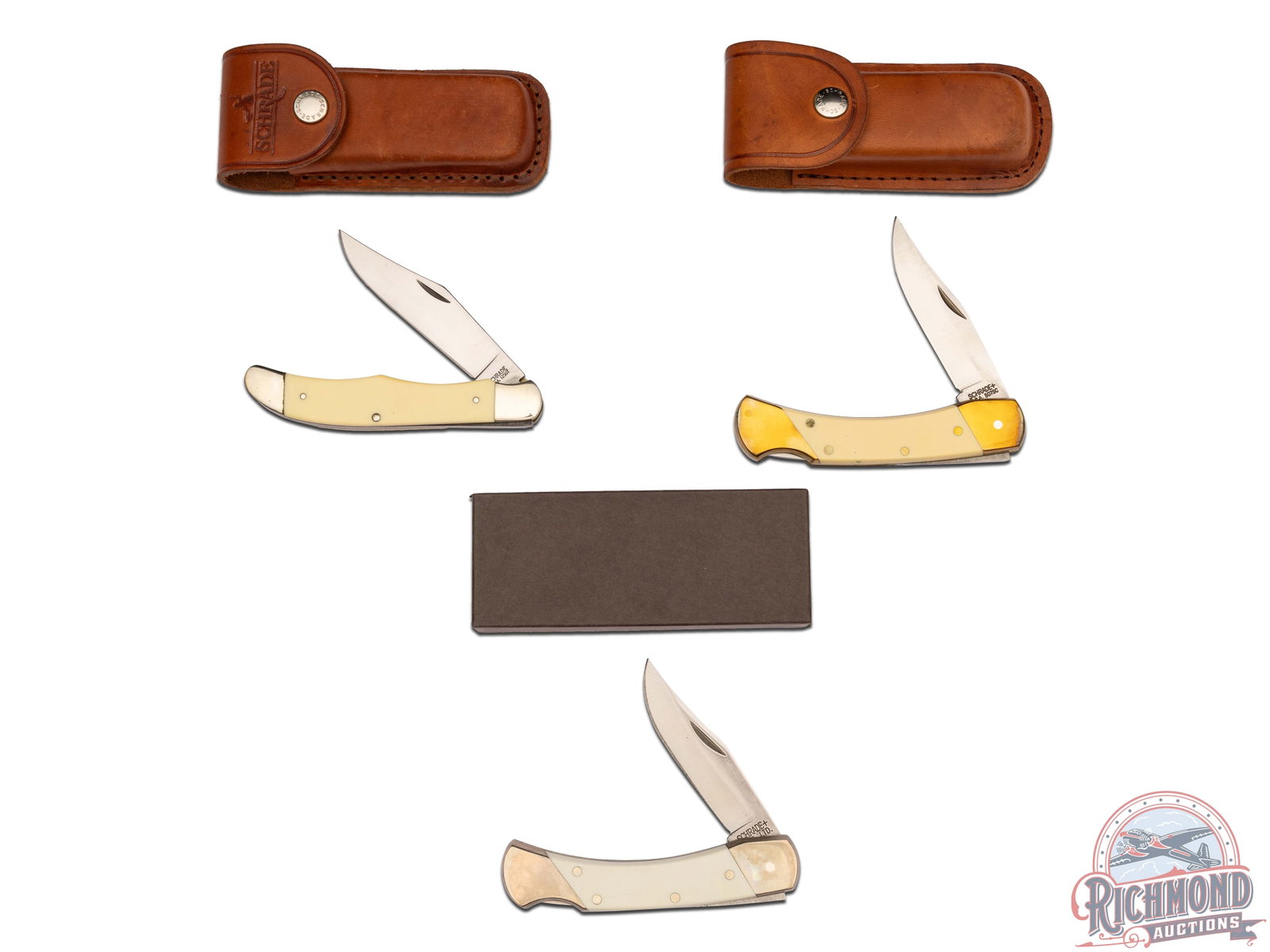 Three Schrade Lockback Folder Knives and Model 1250T Lockblade: Two lockback folder knives, both measure 5" closed, with 3-1/4" blades. One yellow tone handle with brass bolster and liner is stamped model 507SC and includes leather case. Matching folder lockback h