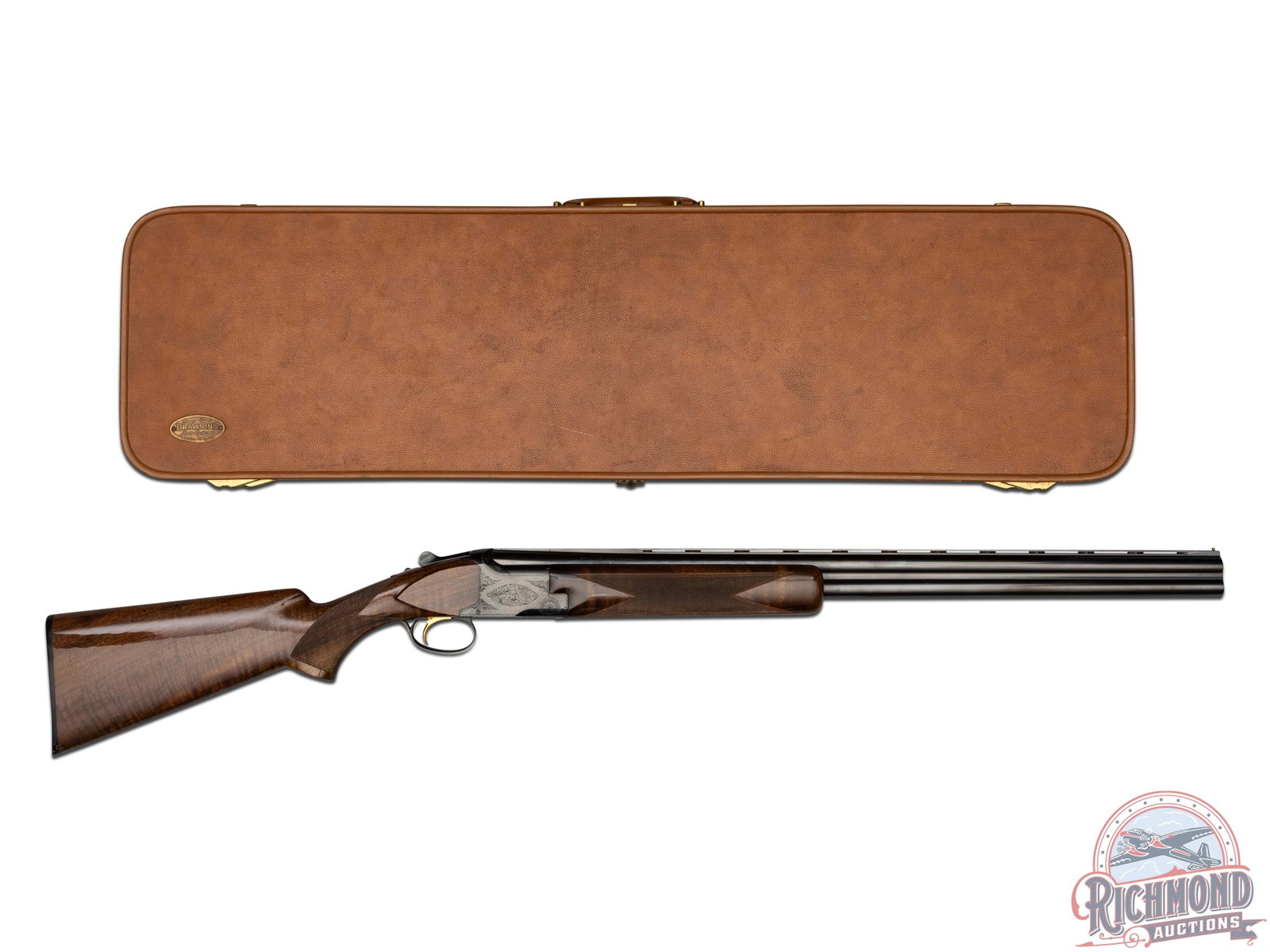Nice Cased Browning Belgian Lightning Superposed 12 Gauge Over / Under Shotgun: This Browning was manufactured in Belgium in 1974. Features 28" ventilated blued barrels chambered for 2-3/4" shells with Full and Modified chokes. Grade I blued engraved receiver with gold washed tri