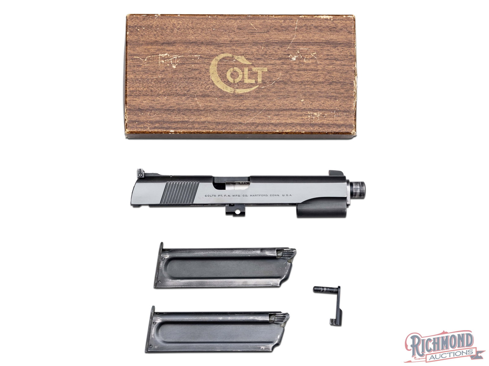 Colt 22 Caliber Conversion Unit For 45 or 38 Automatic Pistol in Colt Wood Grain Cardboard Box: Made by Colt Firearms circa 1955. Kit contains blued wax paper wrapped Colt slide, barrel, springs and 2 magazines for converting a 1911 or 1911A1 to 22 Long Rifle. Comes in Colt marked brown wood gra