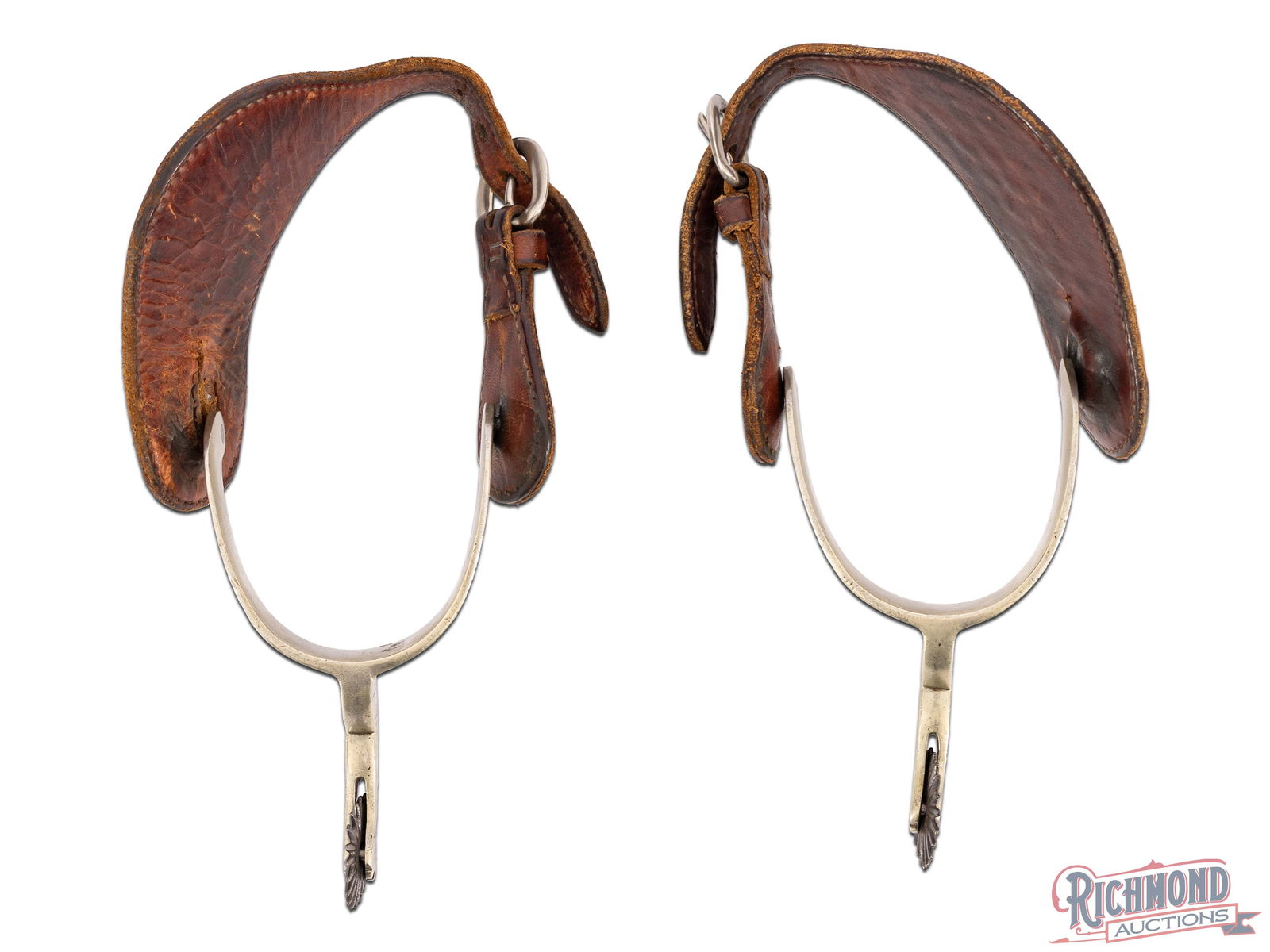 Twenty Point Rowel August Buermann Gal Leg Spurs: Leg spurs marked with the Buermann five point star with good old basket weave leather straps. Straps have stretching around connecting slit. Marked "Patent" over star. Approximately 3" wide and 6-1/2"