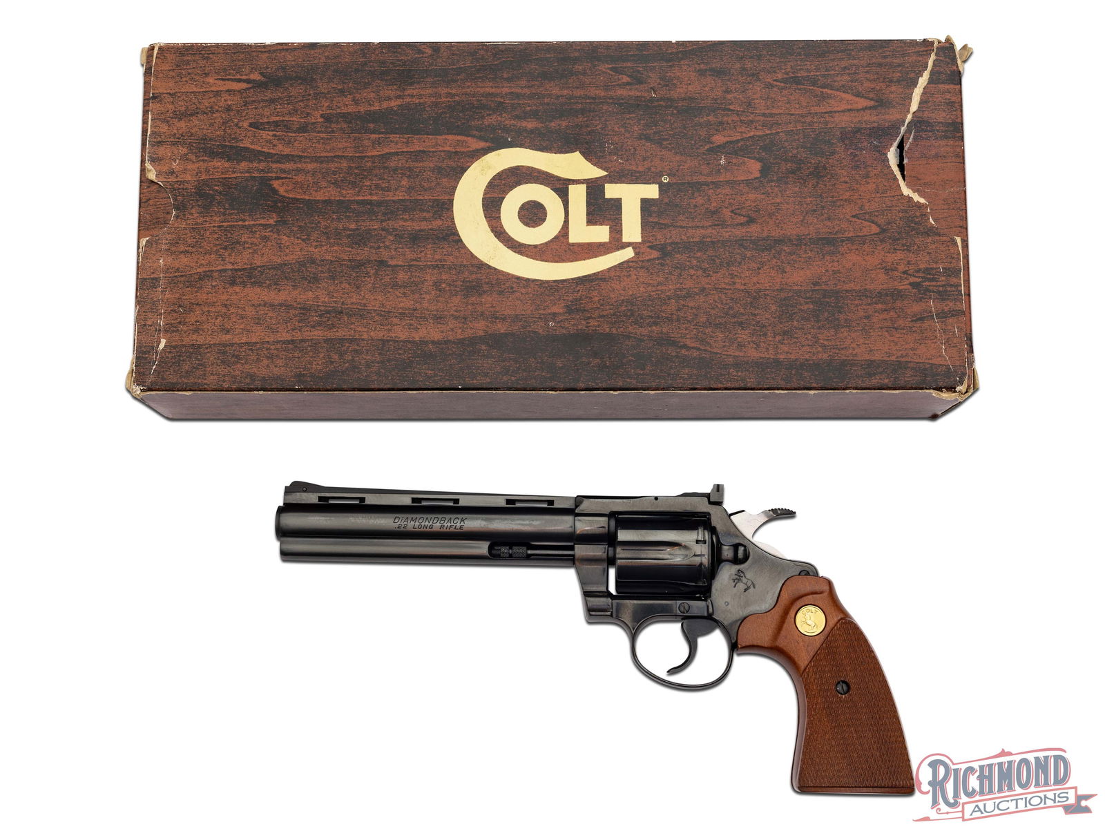 1978 Colt Diamondback 6" .22 LR Double Action Blued Revolver in Original Box: Manufactured by Colt in 1978. Features a 6" blued ventilated rib barrel with rear micrometer adjustable notch and pinned ramp front sight. Full barrel length ejector shroud. Left side is stamped "DIAM