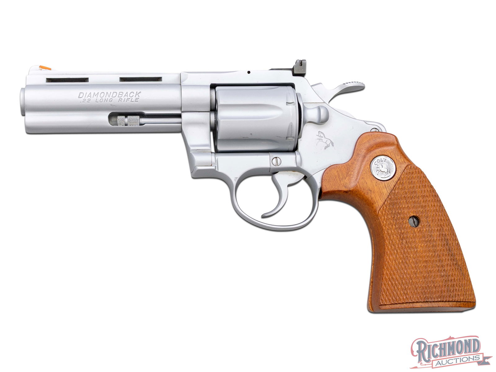 1978 Colt Diamondback 4" .22 LR Revolver in Electroless Nickel: Manufactured in 1977 by Colt. This beautiful snake gun features a 4" ventilated rib barrel with full length ejector rod underlug. Orange highlighted ramp front sight and adjustable notch rear sight. E