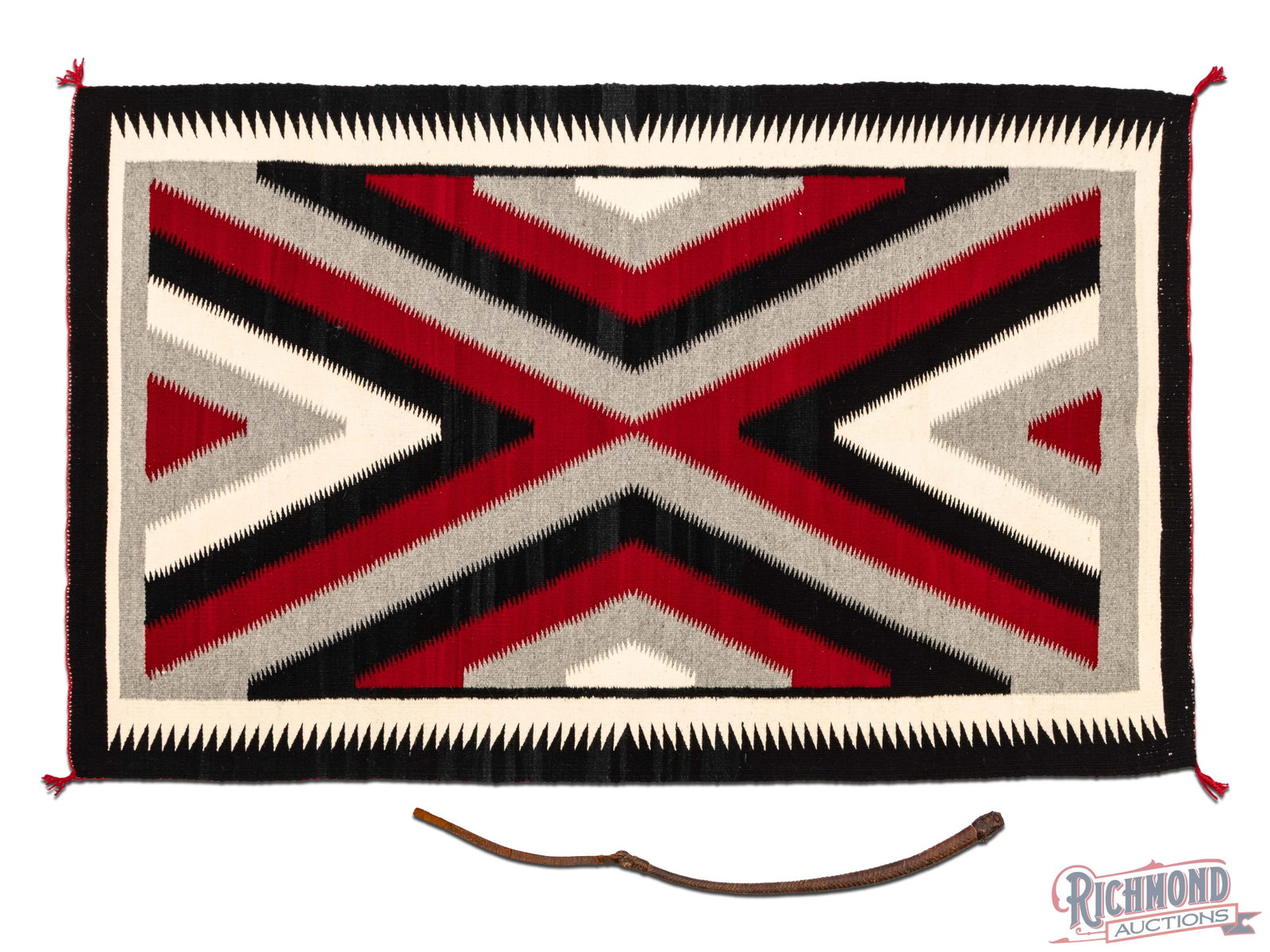 Southwestern Quirt and Large Navajo Dazzler Blanket: A very early saddle leather quirt with attached processed leather end. Offered together with a large southwestern Navajo dazzler blanket that could potentially have been made as a small rug. A good we