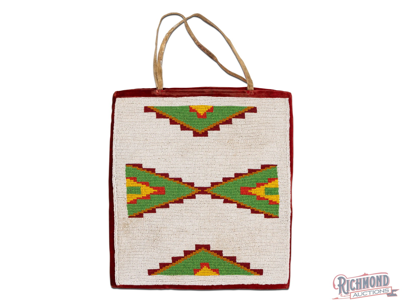 Plateau Leather & Beaded Bag Possibly Nez Perce: Possibly Nez Perce from the first quarter of the 20th century. Beaded on one side with corduroy trade material on the other side and a rawhide handle. Approximately 11-1/4" high and 10-1/4" wide.