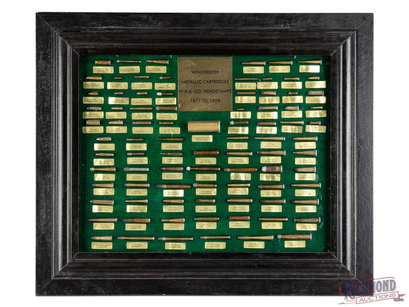 Possible One of Kind Winchester Cartridge Board Plaque Stating Winchester Custom Shop Made in 1969: Lot consists of a Cartridge Board with 86 loaded Winchester Head stamped Cartridges with 6" x 6" brass plate stating "WINCHESTER/METALLIC CARTRIDGES/W.R.A.CO. HEADSTAMPS/1871 TO 1928" with each cartri