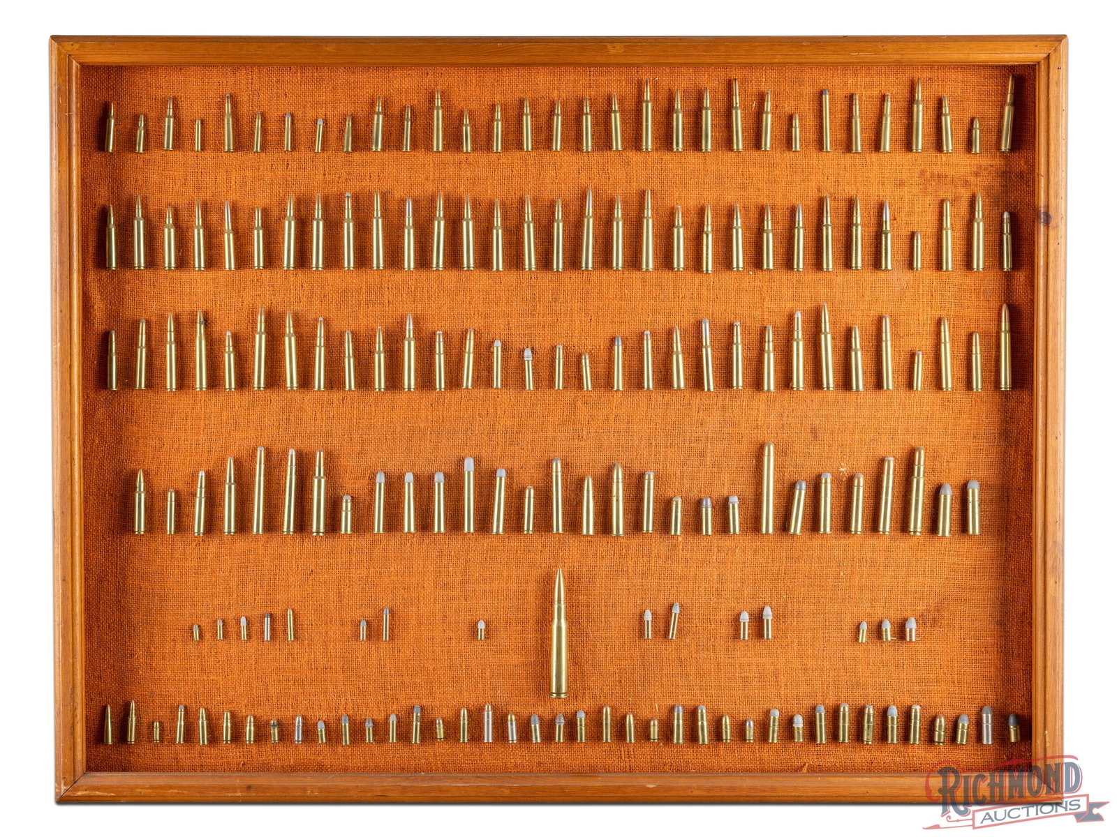 Framed Collection of 177 Rifle and Pistol Shells: Lot consists of 177 Factory loaded Collector Shells ranging from 22 Rimfire to 50 BMG. Collection is mounted on burlap with wood frame. Measures 42" x 31-1/2" x 3".