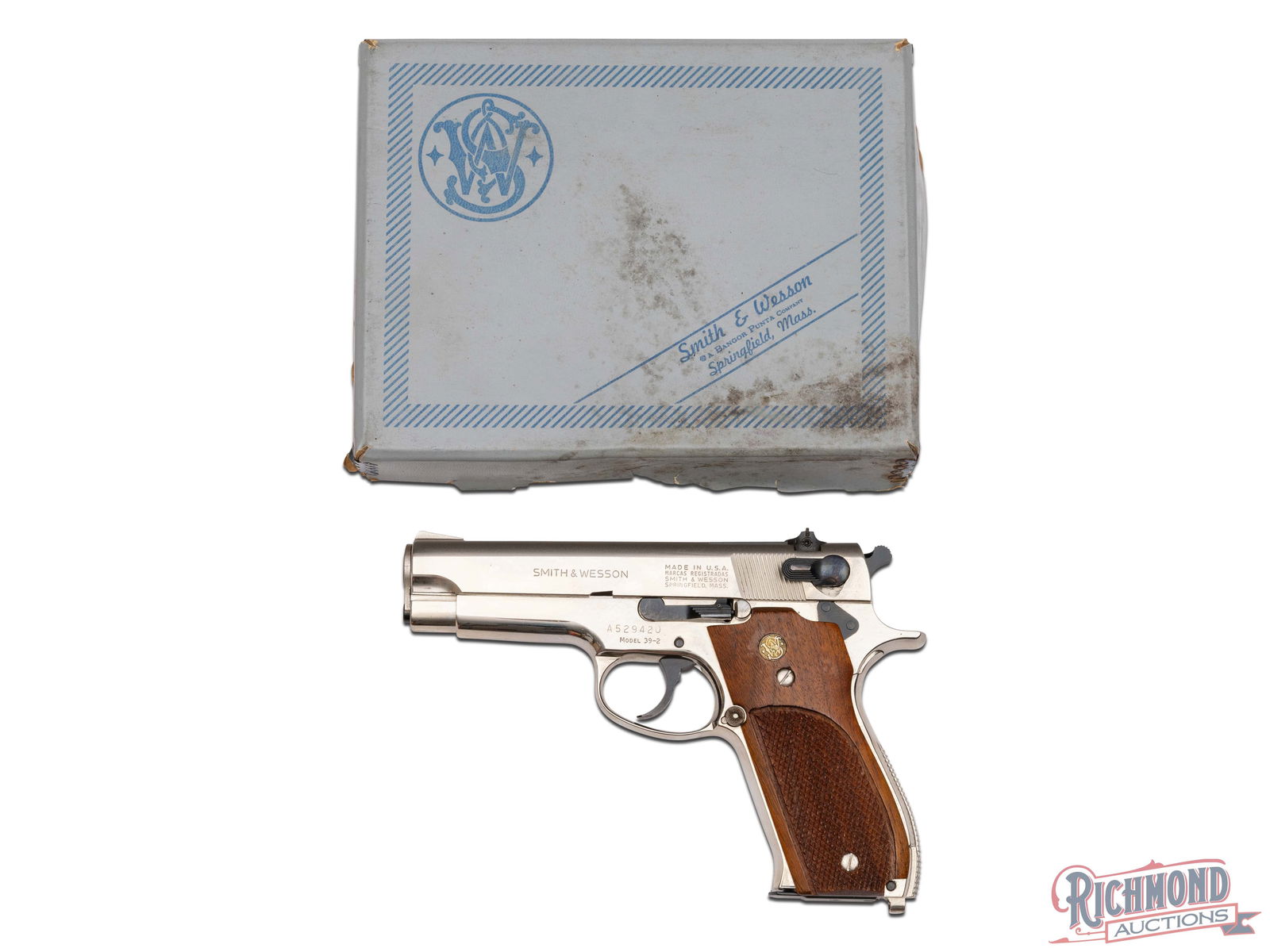 1979 Smith & Wesson Model 39-2 Nickel 9mm Semi-Auto Pistol in Original Box: Manufactured circa 1979. This double / single action pistol features a 4" barrel with rear adjustable notch sight and ramp front sight. Polished nickel finish with satin top. Left side of the slide is