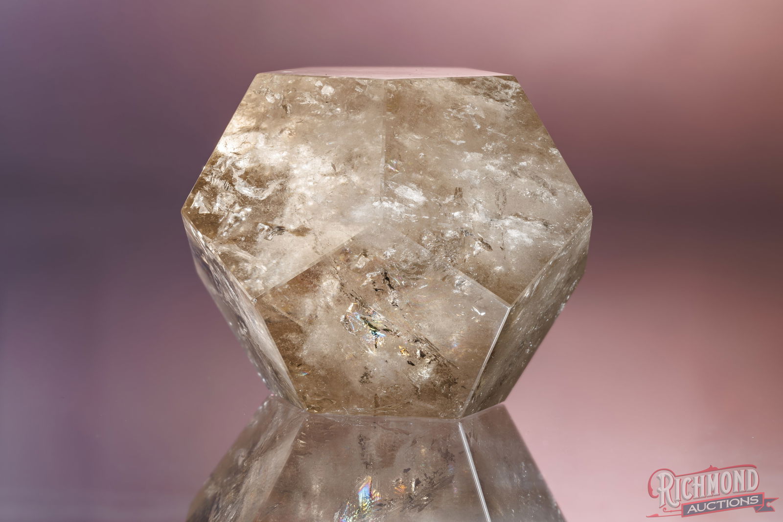 Smoky Quartz Icosahedron Geometric Sphere: This refined smoky quartz has been precision-cut into a truncated icosahedron, a rare geometric form more commonly associated with architectural and design objects than traditional mineral cuts. The s
