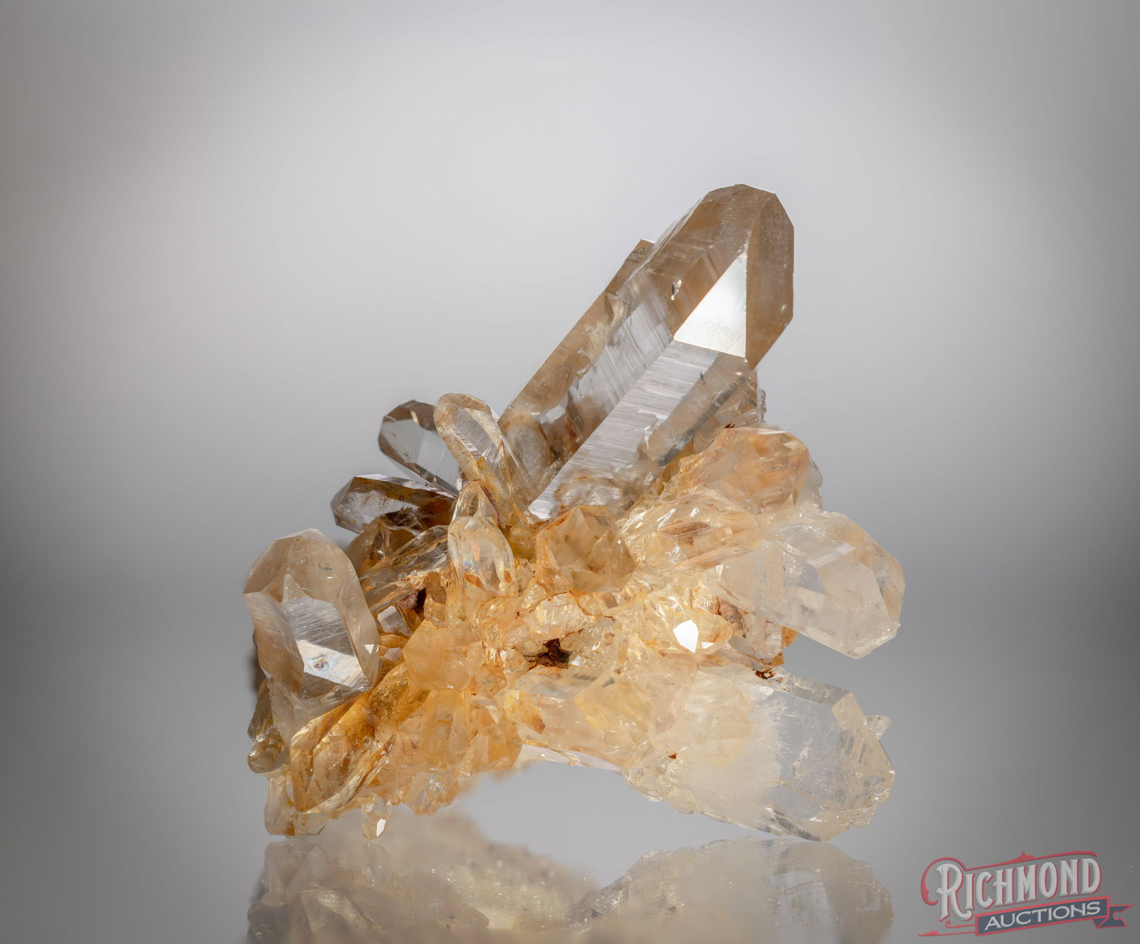 Small Tangerine Quartz: This palm-sized tangerine quartz cluster features well-defined crystal points with warm iron-oxide coloration concentrated throughout the core and matrix. The crystals display strong natural luster an