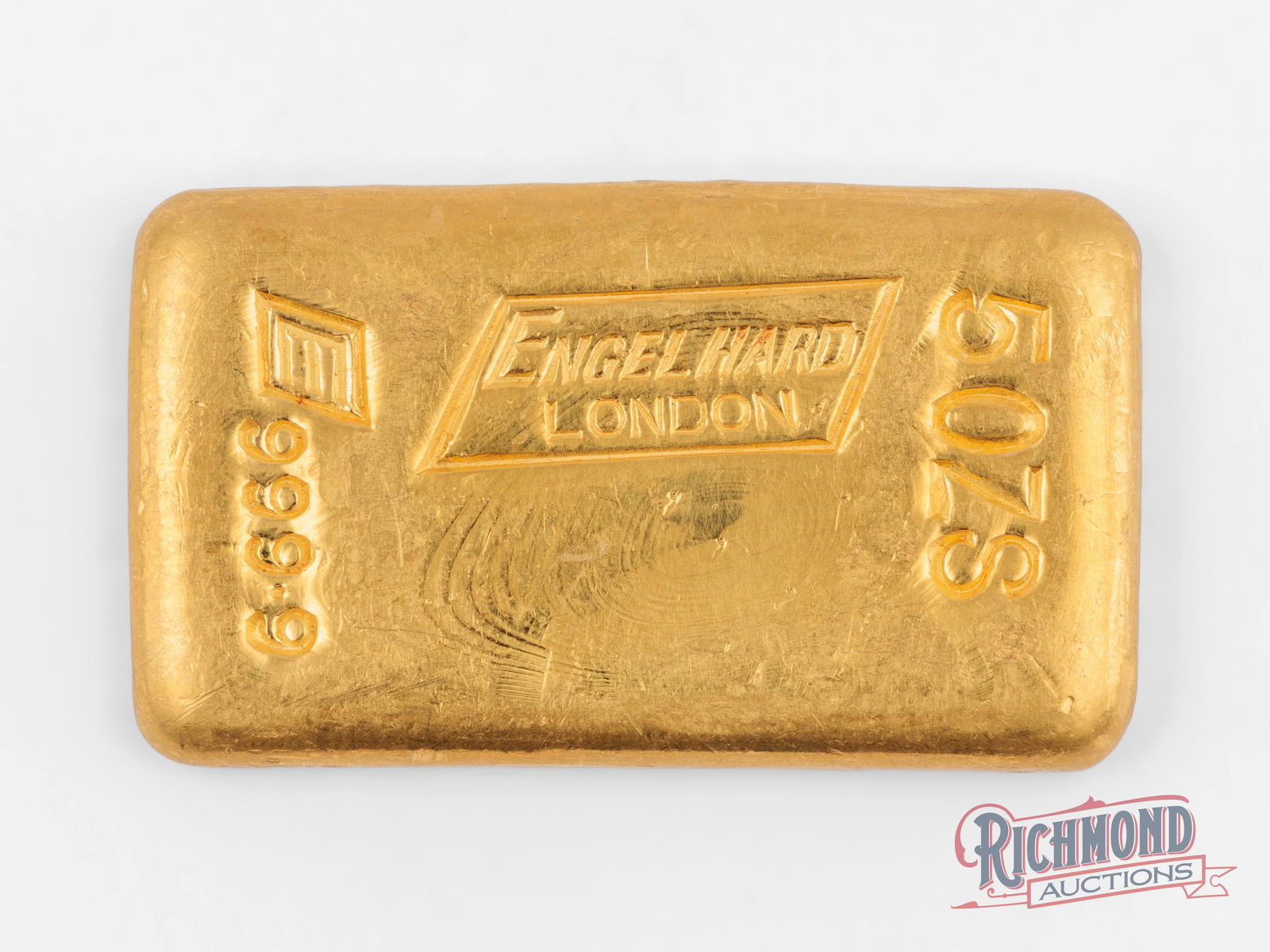 A Rare Early Date 5 oz Engelhard London Gold Bar: This Engelhard-London bar was produced in the early days of the Engelhard Refining Company. There are two main varieties of this bar, the plain-back version as offered here, and a waffle-back bar with