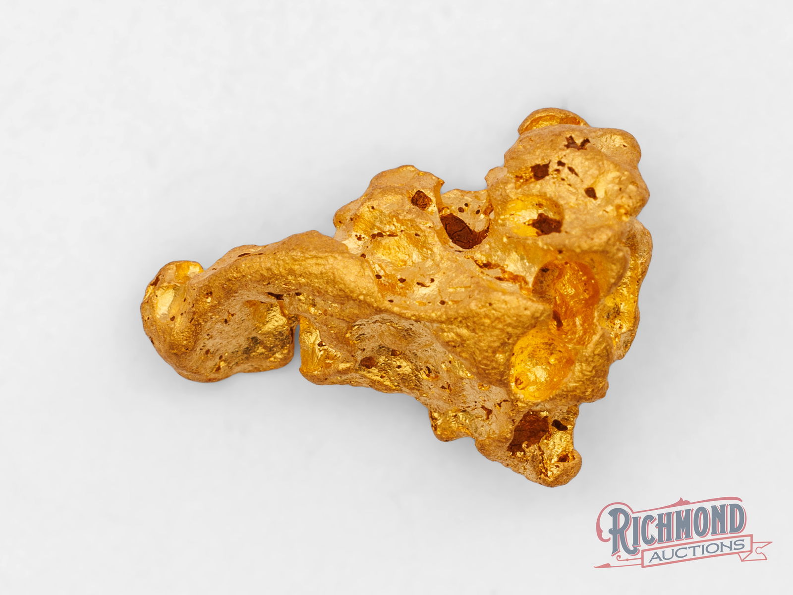 8.6g Natural Gold Nugget: Recovered near the surface in the Golden Triangle, this nugget shines with natural brilliance and rich luster. Its heavily water-worn shape tells the story of a nugget that travelled far from its orig