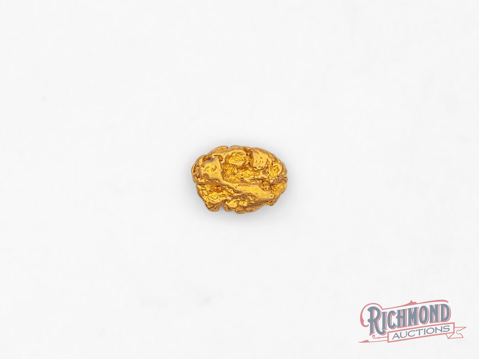 1g North American Gold Nugget: This North American alluvial picker nugget was recovered from a creek system where time and flowing water slowly released the gold and shaped it into its present form. Its gently rounded edges and nat