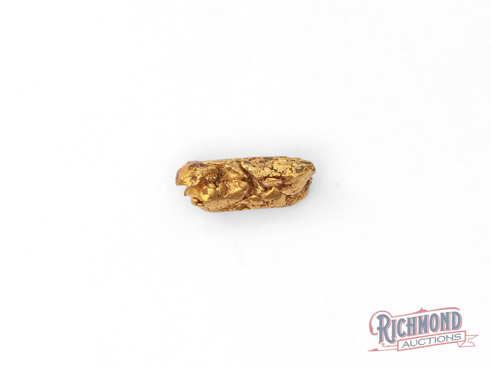 2.1g North American Gold Nugget: This North American alluvial picker nugget was uncovered from a creek system where water has slowly done the work of freeing and shaping the gold over time. Its compact size and softly rounded form ar