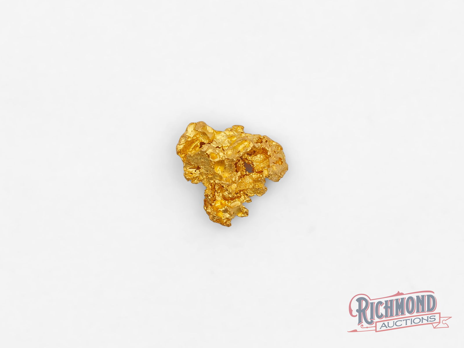 0.9g Natural Gold Nugget: This nugget was naturally formed and later discovered by the Mahoney's in Kalgoorlie, WA. Each curve and surface is unique, making it a one-off representation of nature's unpredictability. PURITY: 22k