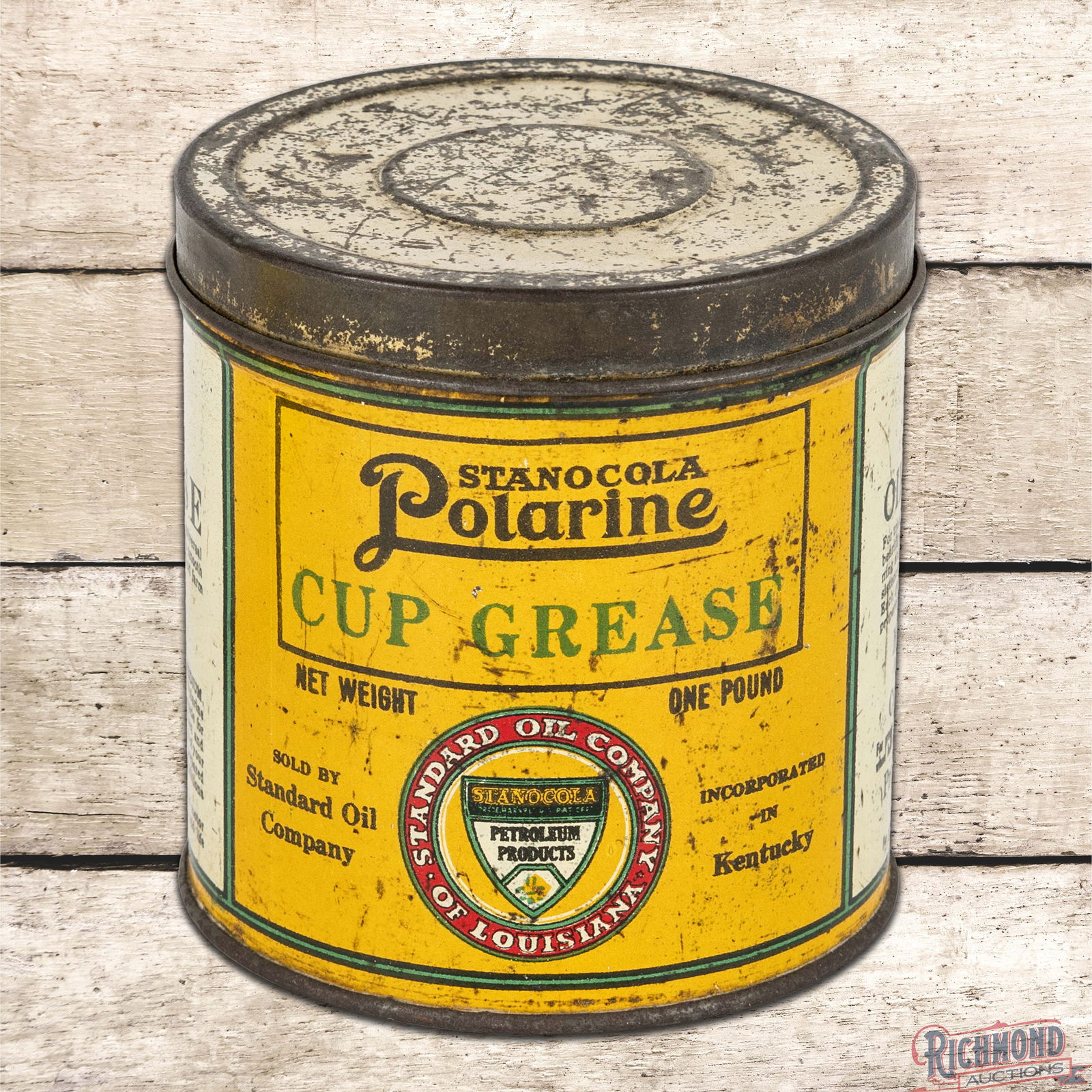 Stanocola Standard Oil Co of Louisiana Metal 1 Pound Grease Can w/ Logo: Empty one pound grease can with the original lid has good color and shine. The display features a bright logo with fine scratches, small paint chips and small dent in the left field. The reverse of th
