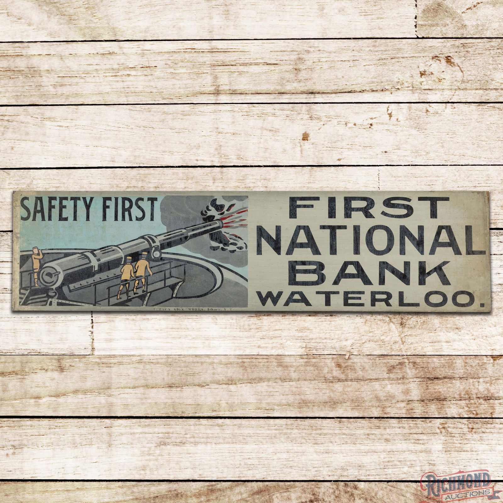 Superb Safety First National Bank Waterloo Single Sided Tin Ithaca Sign w/ Soldiers & Cannon: NOS (New Old Stock) SST (Single Sided Tin) sign has excellent color and shine. The field features a military scene with soldiers and a large cannon. The sign exhibits light storage wear in the fields