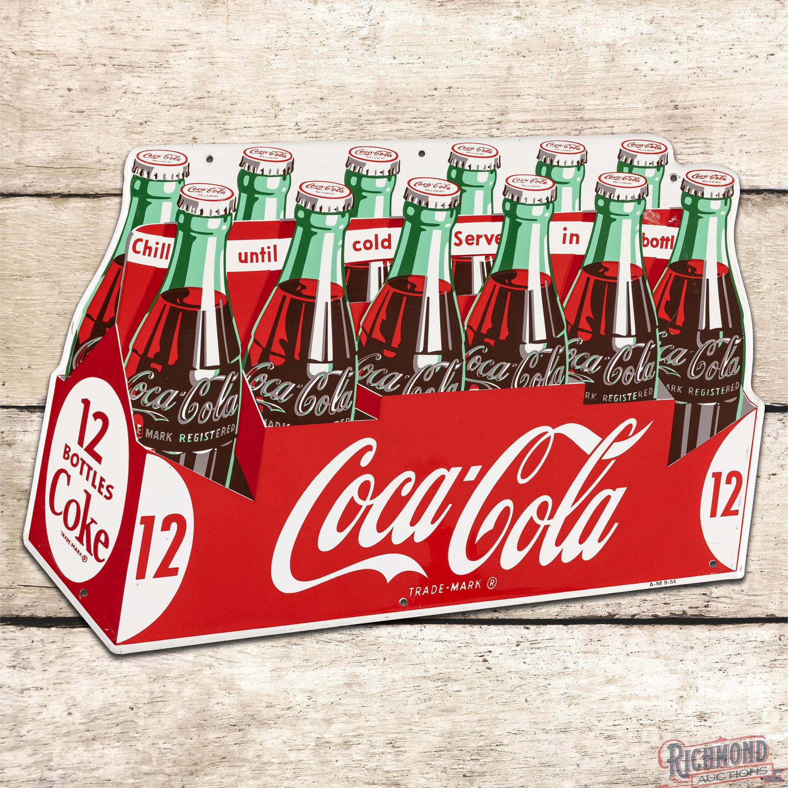 1954 Coca Cola Single Sided Tin Die Cut 12 Pack Sign: SST (Single Sided Tin) die cut sign has outstanding color and shine. The display field of the sign is exceptionally clean. The outer fields exhibit light wear with fine scratches and an area of