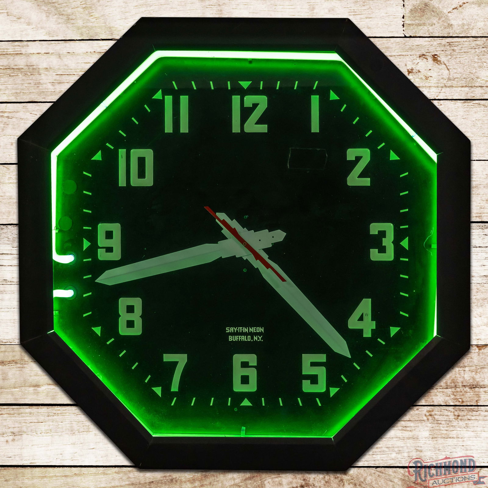 Say It in Neon 32" Octagon Advertising Clock: Say it in Neon advertising clock has been professionally restored. The clock and neon both work as they should. The clock features a clean inner face with embossed numbering and light wear. The hands