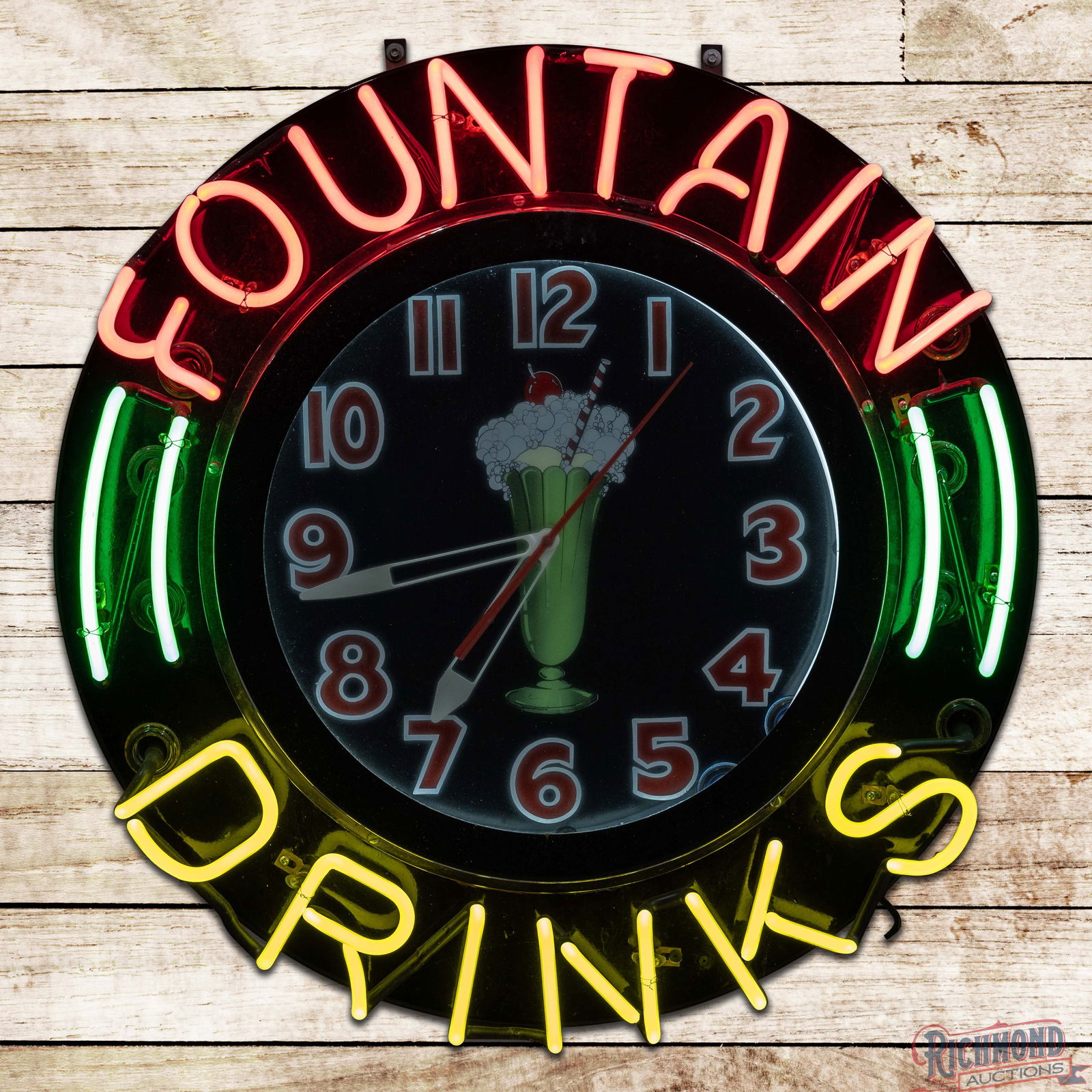 Fountain Drinks 26" Neon Clock w/ Ice Cream Sundae: Factory neon advertising clock has been professionally restored. The clock features ice cream float graphics in the field with vibrant four-color neon. The inner face and outer face are clean. The chr