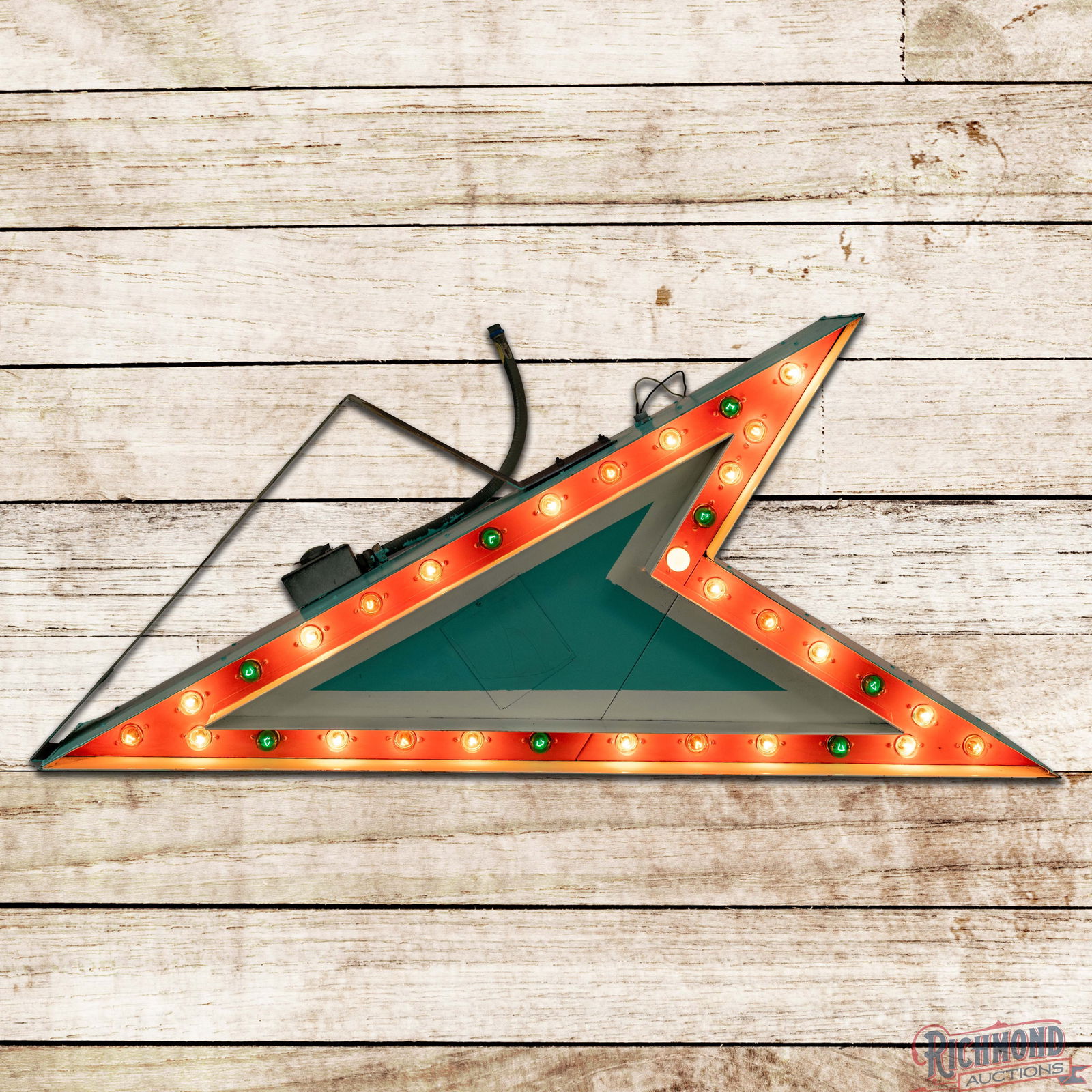 Die Cut 3D 4.5' Flashing Bulbed Arrow Sign w/ Bracket: Double sided die cut bulbed arrow sign with factory mounting bracket has good color and shine. The sign features sequenced flashing multi-colored bulbs along the perimeter on both sides. The display p