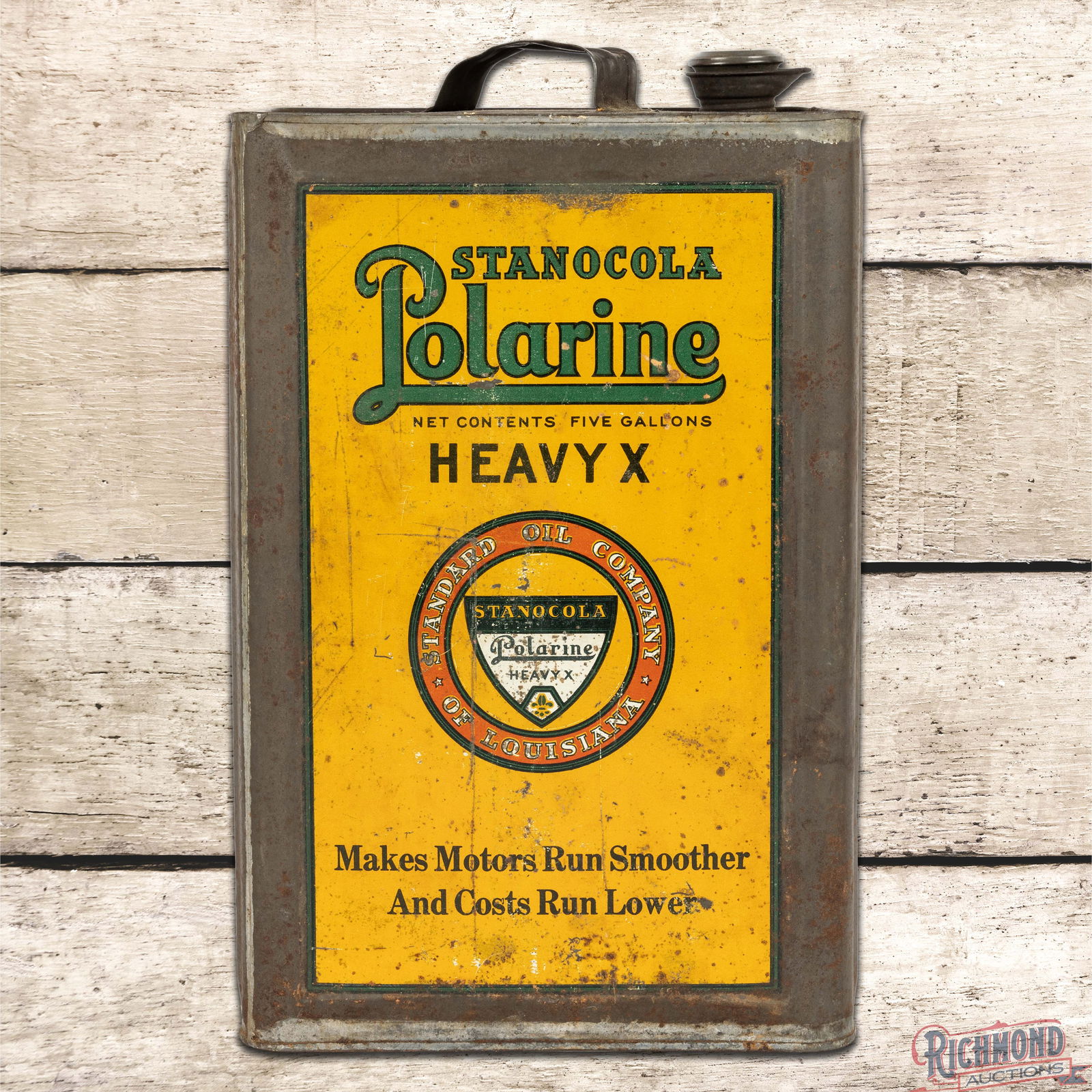 Stanocola Polarine Heavy X 5 Gallon Metal Motor Oil Can w/ Logo: Empty five-gallon metal can with a handle and cap has good color and shine. The display has fine scratches, paint chips and oxidation present. The reverse is in a similar condition. The sides have hea