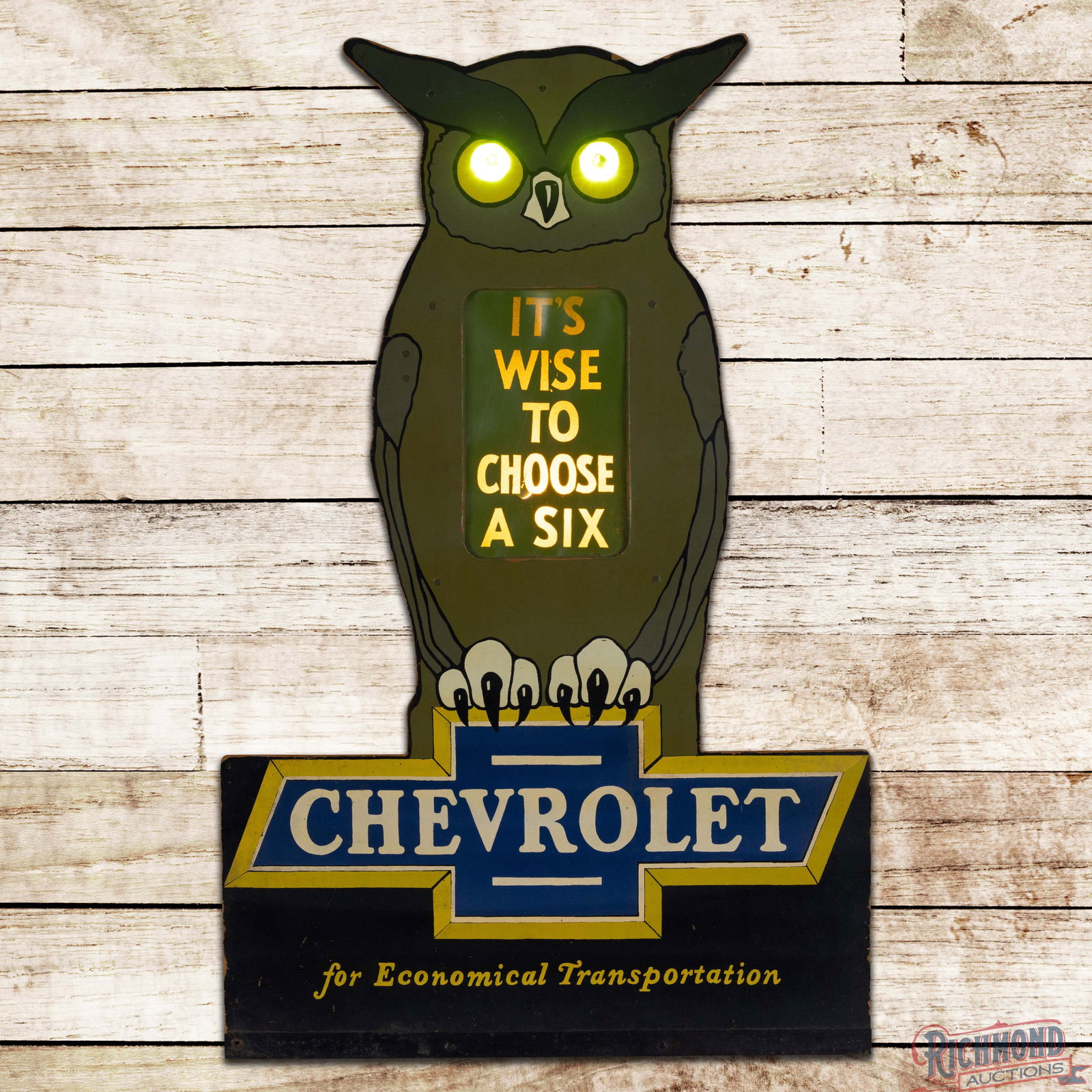 1920s Chevrolet for Economical Transportation "It's Wise to Choose a Six" Lighted Countertop Sign: Outstanding single-sided internally lighted die cut Masonite countertop easel back display has excellent color and shine. When powered on, the panel in the center and the jeweled eyes light up. The