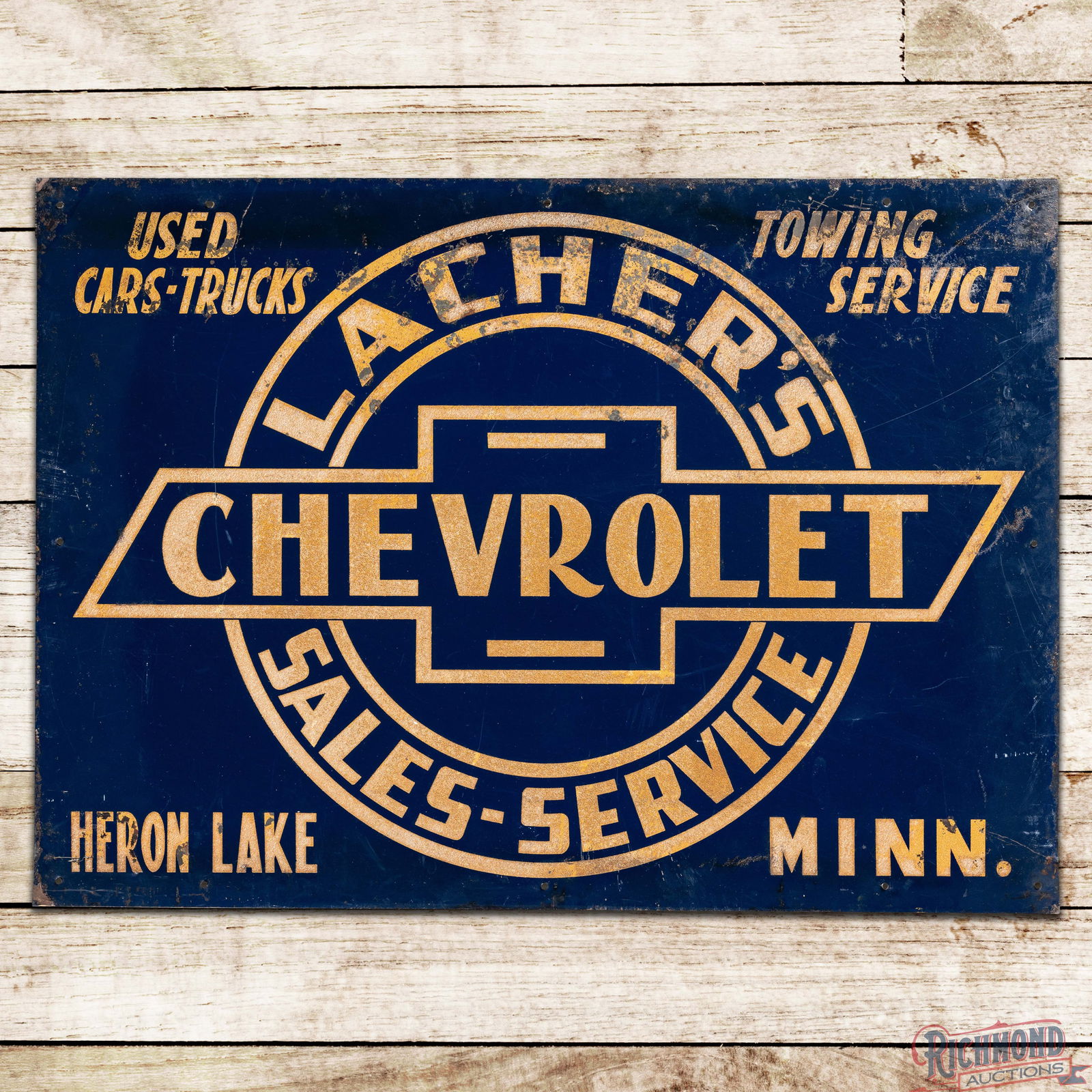 Lacher's Chevrolet Sales & Service Heron Lake Minn SS Tin Sign w/ Reflective Lettering & Logo: SST (Single Sided Tin) sign with reflective lettering and a wooden support frame has very good color and shine. The field has toning to the reflective lettering with light wear and paint chips in the