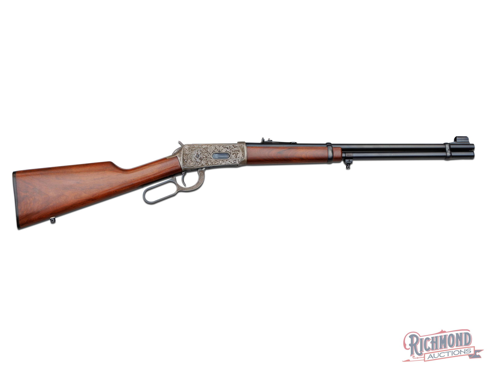 Winchester 94 Lever Action Carbine Rifle in .30-30 WIN Intricately Engraved by R.W. Baird: Manufatured by Winchester in 1980 and exquistely upgraded by R.W. Baird. This rifle features a 20" blued Winchester proof steel barrel with rear slide adjustable notch and hooded ramped blade front si