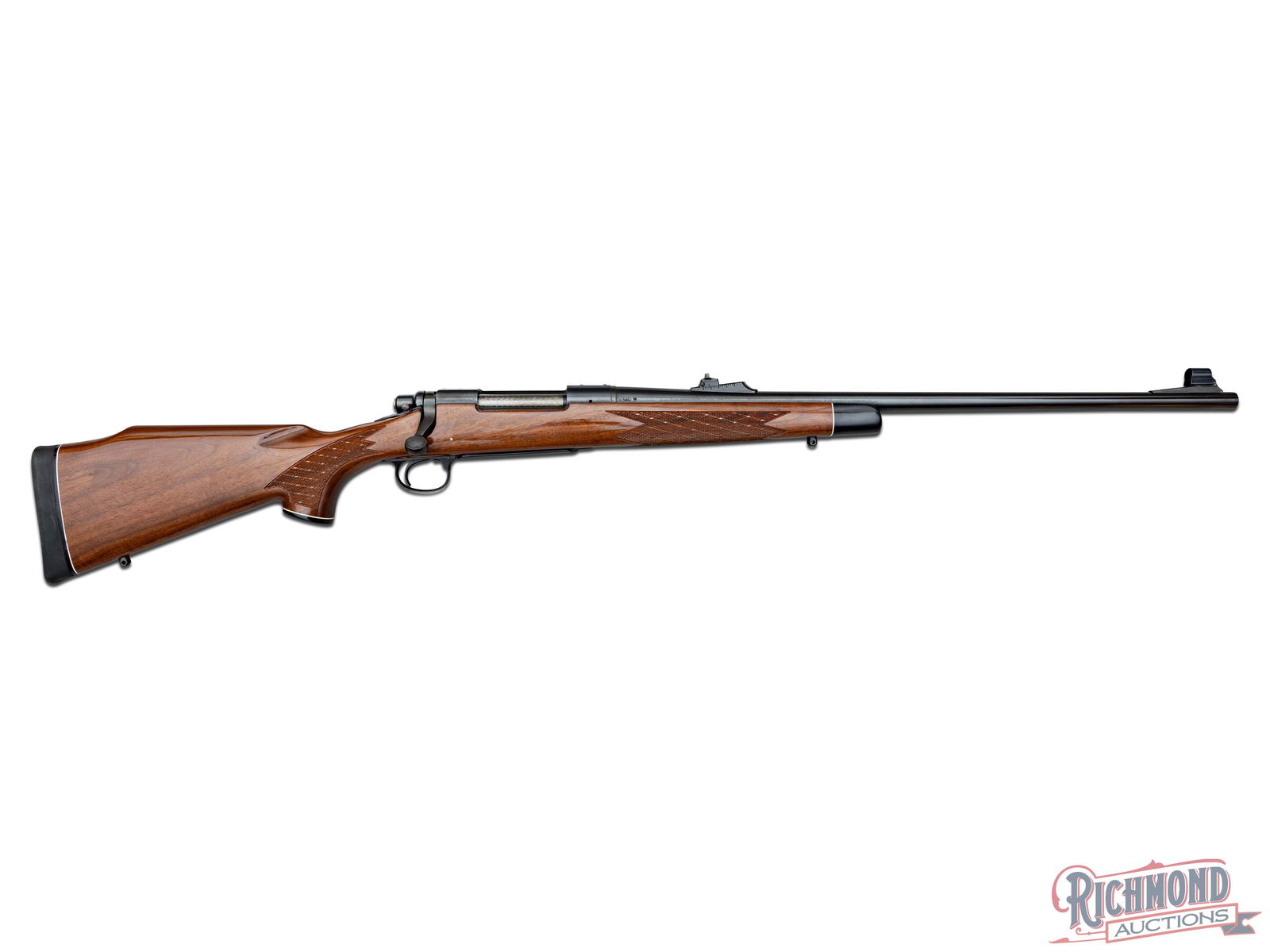1979 Remington Arms Model 700 BDL 7mm REM Mag Deluxe Bolt Action Rifle: Manufactured by Remington Arms in 1979 according to the date code "PV". Features a 24" blued tapered barrel with ramped slide adjustable notch rear sight and ramped hooded front blade sight. Receiver