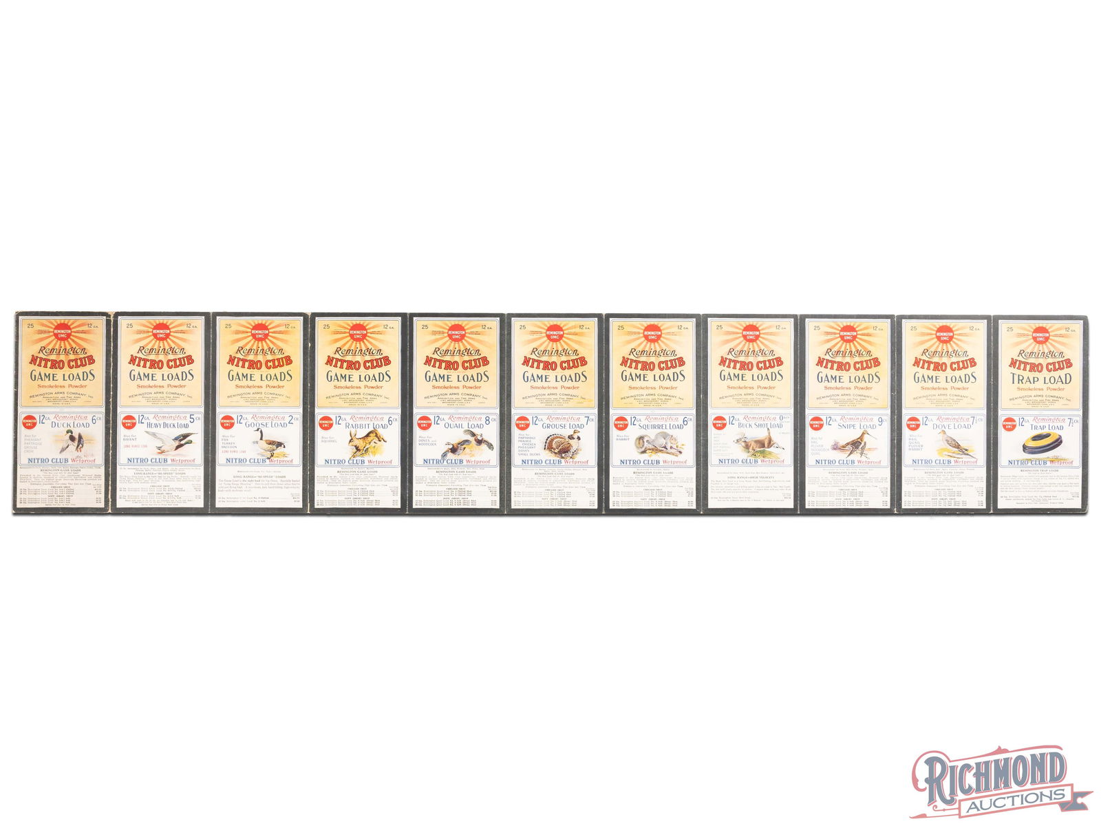 Group of 11 Remington Nitro Game Load Shotgun Shell Labels Display Sign: Group of eleven Remington Nitro Game Load labels have been attached to cardboard. The labels have excellent color with minor imperfections. The cardboard reverse has small edge chips with light wear.