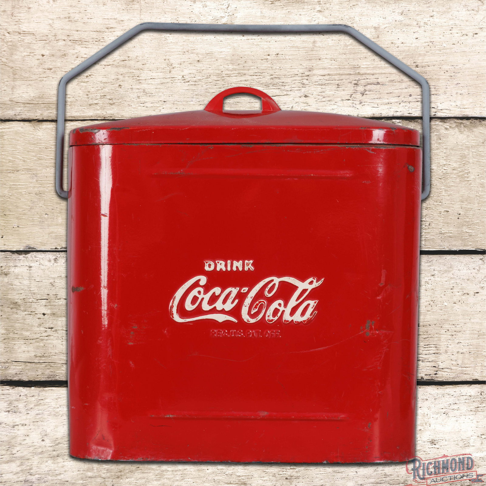 Drink Coca Cola Sterling Metal Drink Box Cooler: Metal Sterling Coke cooler with handle and the original lid. The cooler presents with original paint, wear, small dings and oxidation along the lower edges. The bottom is marked Made by Sterling Mfg. 