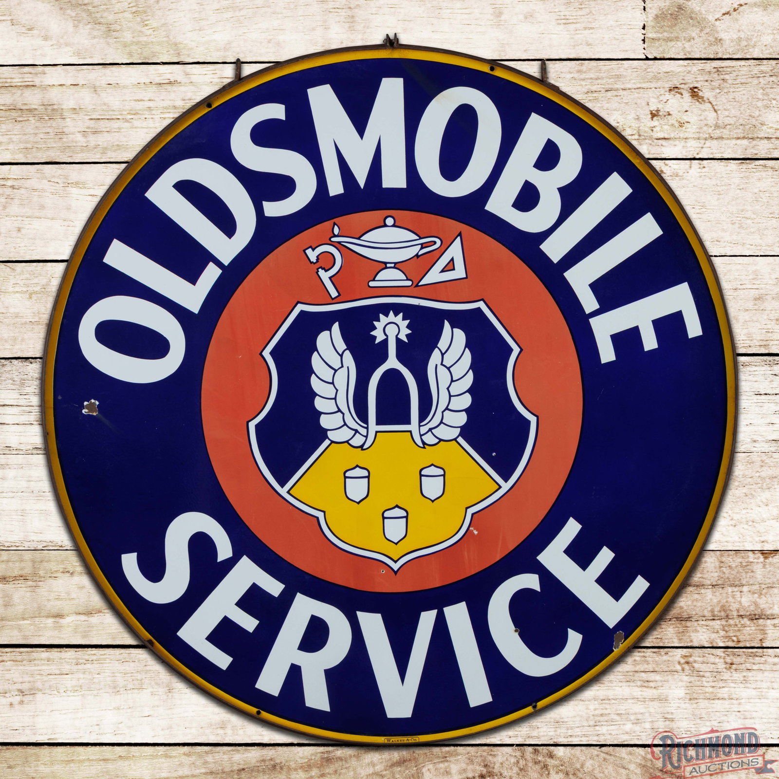 Oldsmobile Service 5' Double Sided Porcelain Sign w/ Ring "Crest Logo": DSP (double sided porcelain) sign with a metal ring has very good color and gloss. The display has fading to the red porcelain enamel with areas of light surface wear. The outer fields and perimeter h
