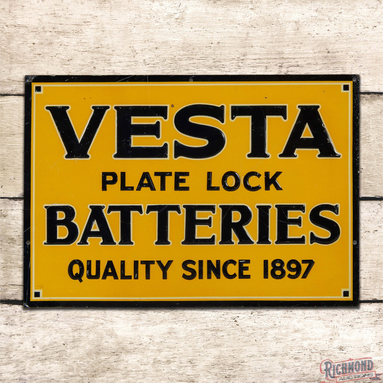 Vesta Plate Lock Batteries Quality Since 1897 Emb. Single Sided Tin Sign: SST (single sided tin) embossed sign has very good color and shine. The field has fine scratches with faint vertical bends in the left fields and small areas of color match in the black lettering. The