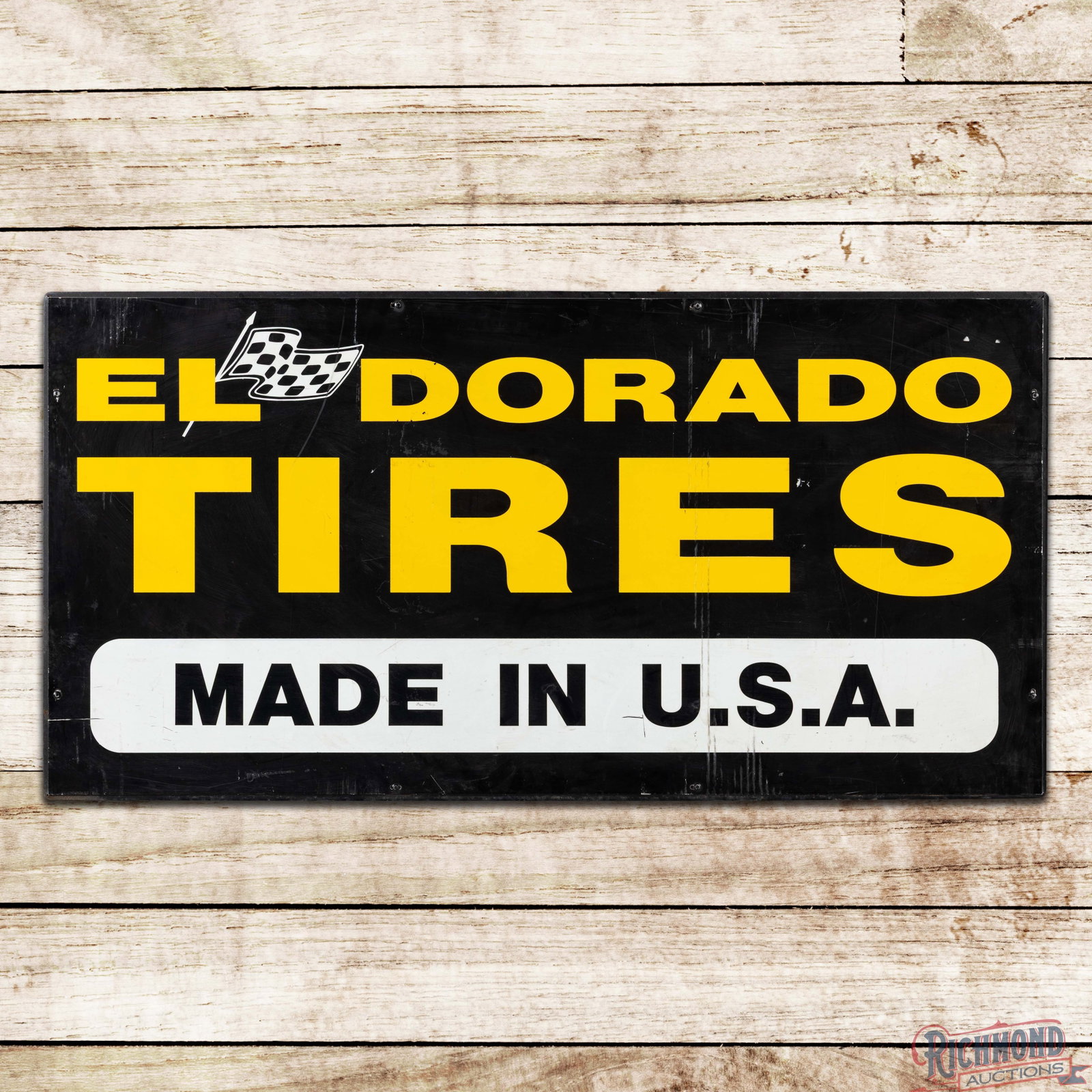 El Dorado Tires "Made in U.S.A. 4' Single Sided Tin Sign w/ Checkered Flag Logo: Single sided aluminum sign with the factory metal support frame has good color and shine. The display has fine scratches with vertical wear marks in the right fields and small areas of paint loss. The