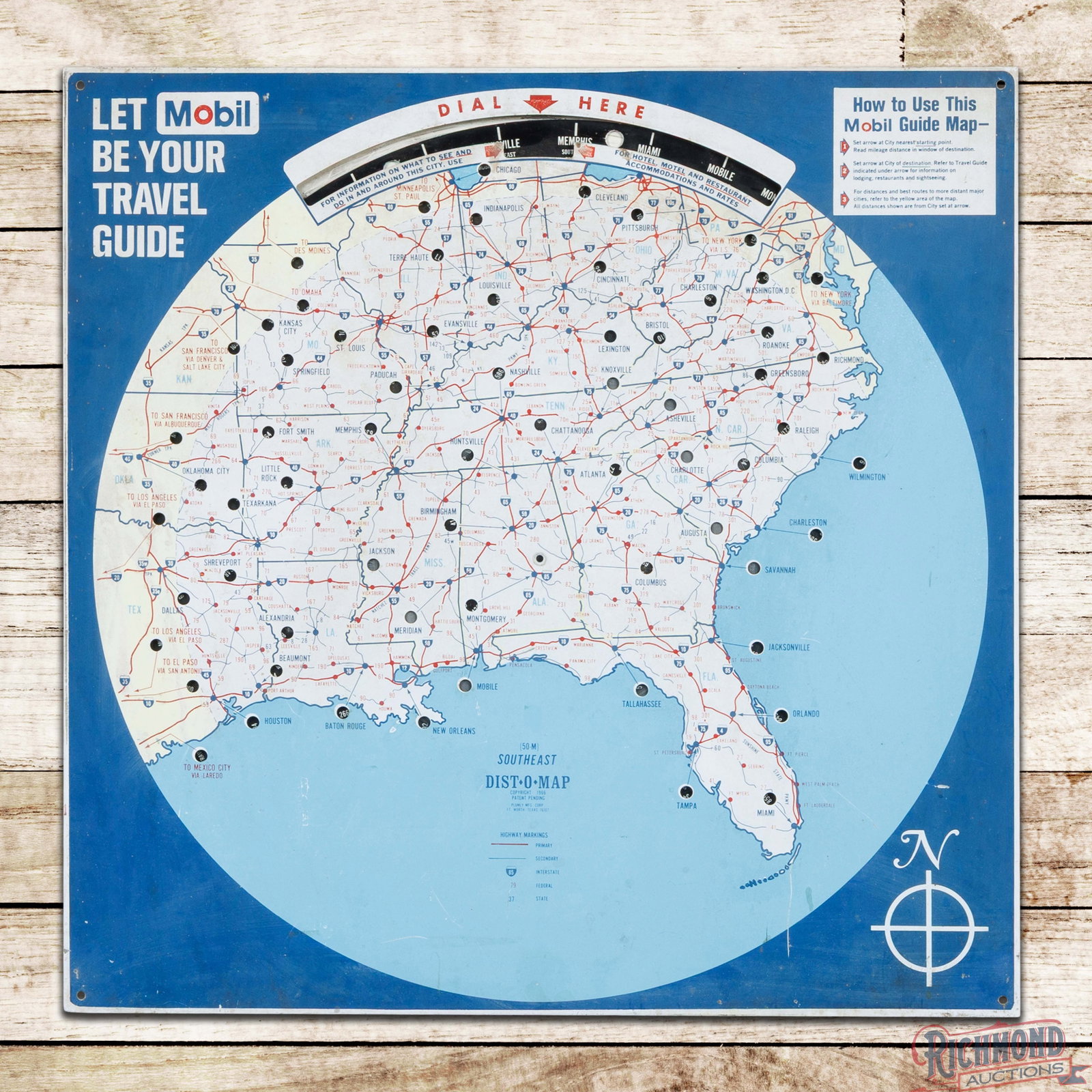 1966 Mobil Southeast Service Station Travel Guide "Mileage Meter" Single Sided Tin Sign: SST (single sided tin) sign with mileage dial has good color and shine. The display has light wear throughout with toning and fine scratches in the outer fields. The perimeter has minor bends along th