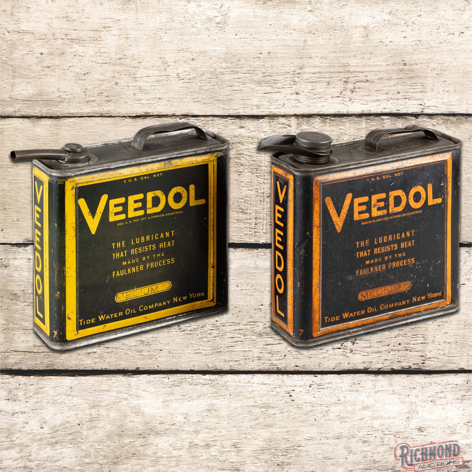 Group of Two Tidewater Veedol Motor Oil Gallon Cans: Group of two empty Veedol metal gallon cans. The first can has brighter paint with general surface wear and paint chips to the graphic and bends along the upper right edges. The reverse and sides have