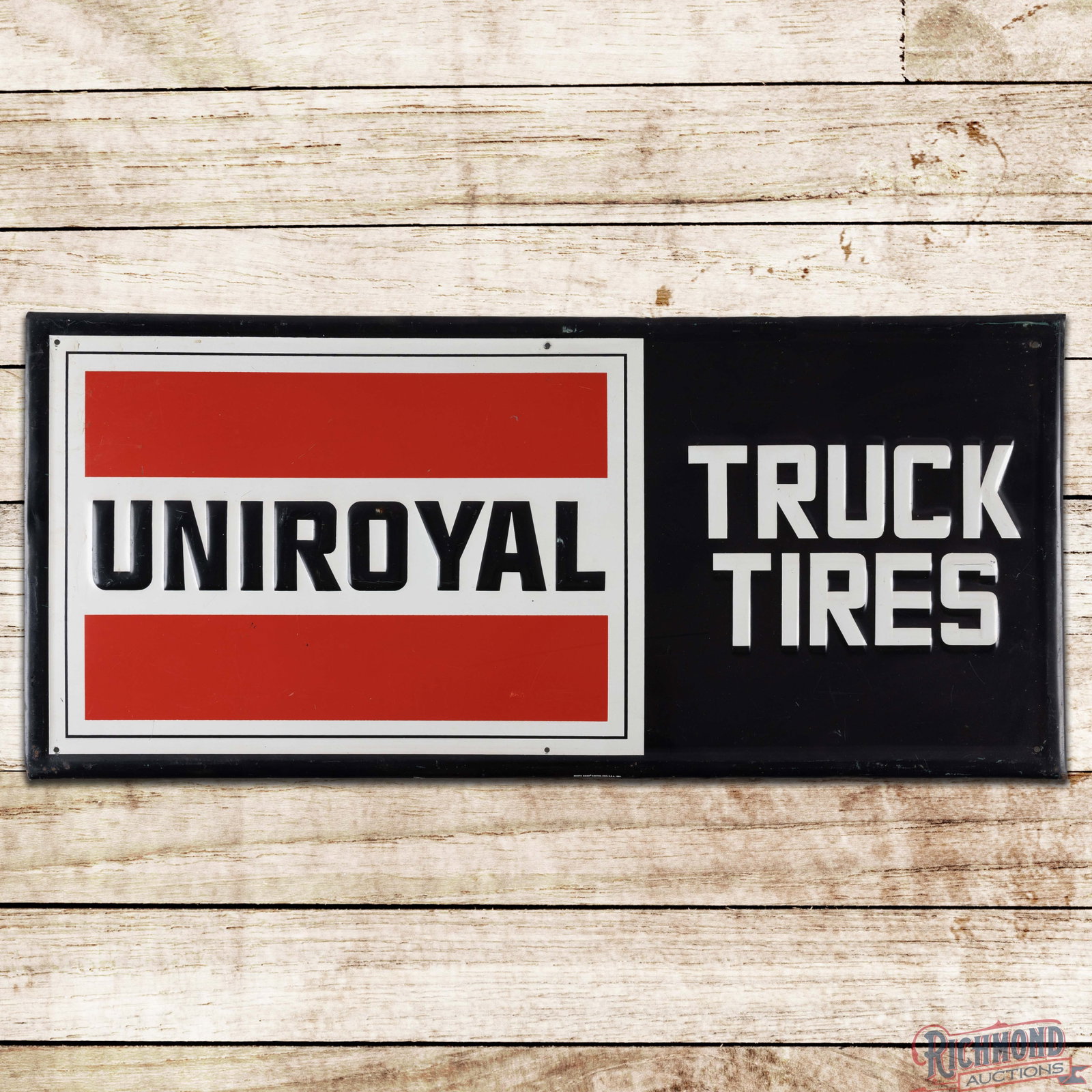 Uniroyal Truck Tires 40" Emb. Single Sided Tin Sign: SST (single sided tin) embossed self-framed sign has good color and shine. The field has light wear throughout with fine scratches and rubs. The perimeter has minor bends, paint chips and fine scratch