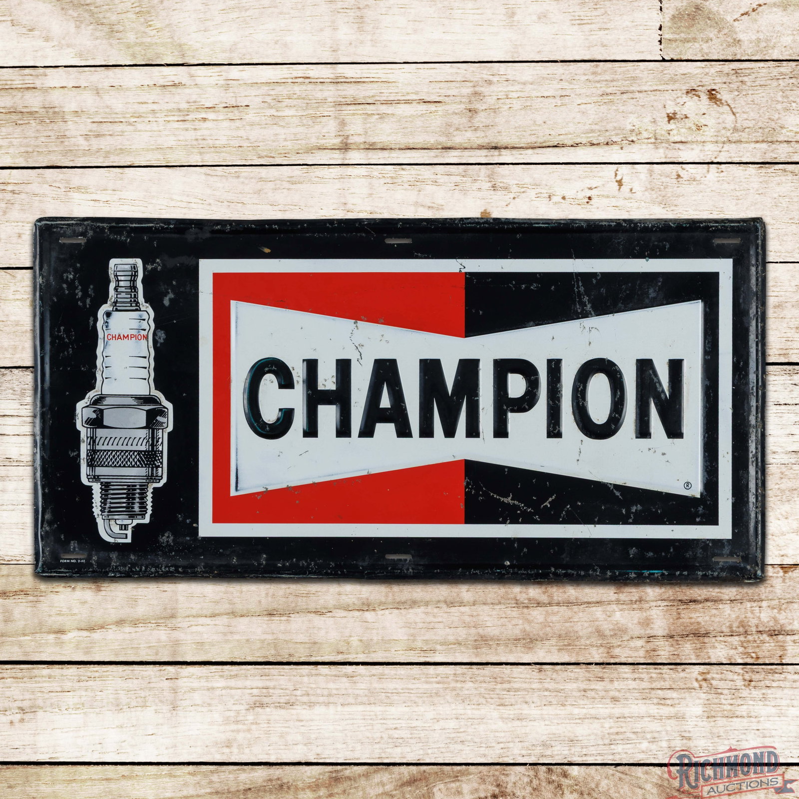 Champion Spark Plugs 36" Emb. Single Sided Tin Sign: SST (single sided tin) embossed self-framed sign has good color and shine. The sign has general age-related wear throughout with oxidation, scratches and paint chips in the fields. The perimeter has s