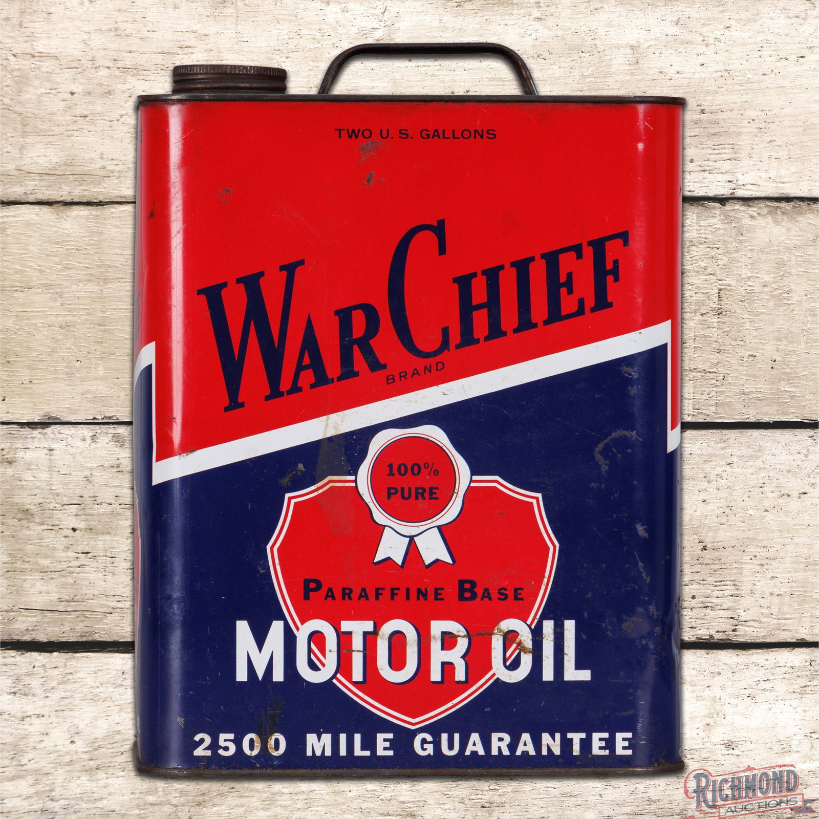 War Chief Paraffine Base Motor Oil Two Gallon Metal Can: Empty two gallon metal can has very good color and shine. The can has light wear, surface imperfections and small indentations. The original cap and handle are present. 11.5" H. Condition: 8. All item
