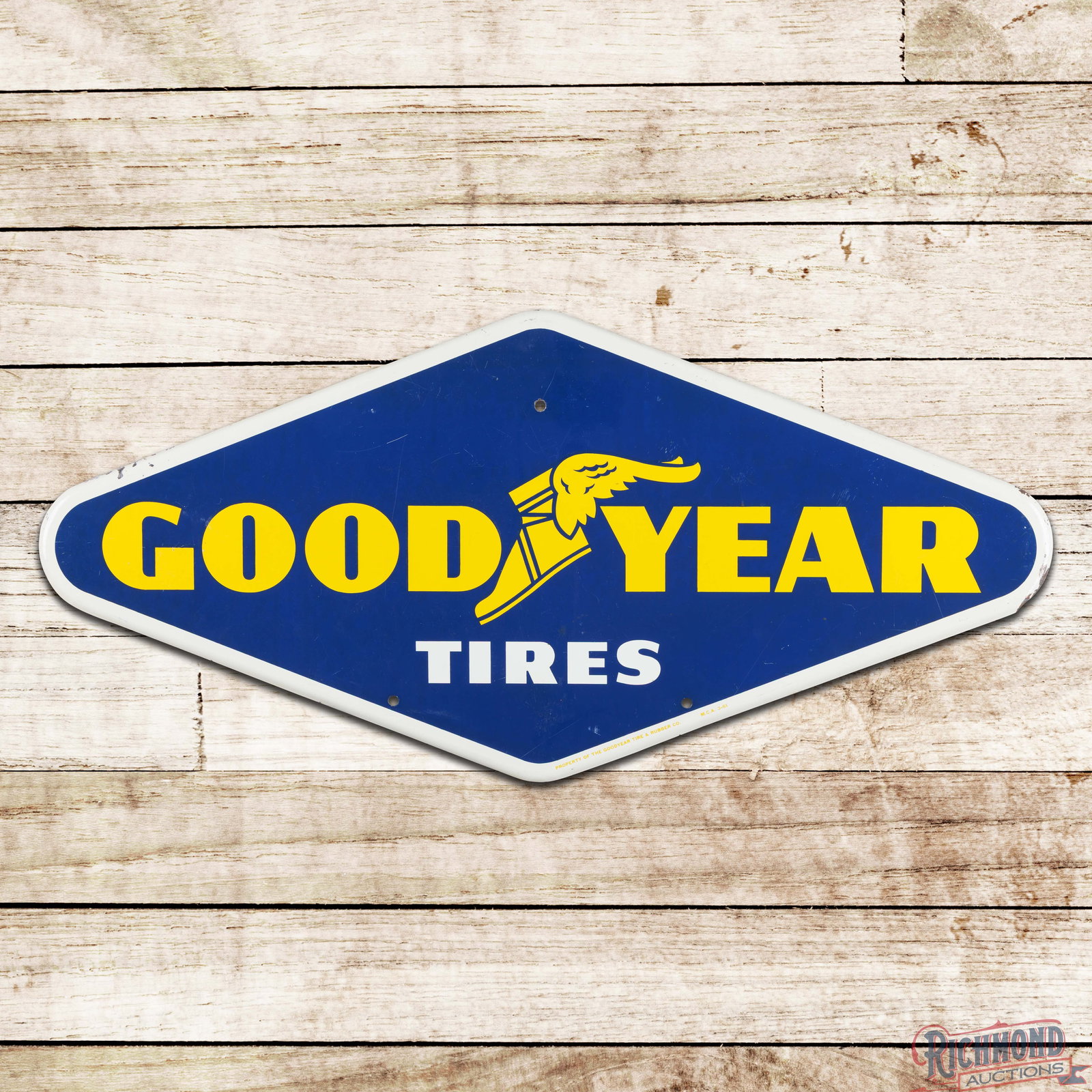 1961 Goodyear Tires 28" Single Sided Tin Sign w/ Wingfoot: SST (single sided tin) rolled edge tire rack sign has very good color and shine. The display has light wear with fine scratches. The perimeter has paint chips with a minor bend on the right hand edge.