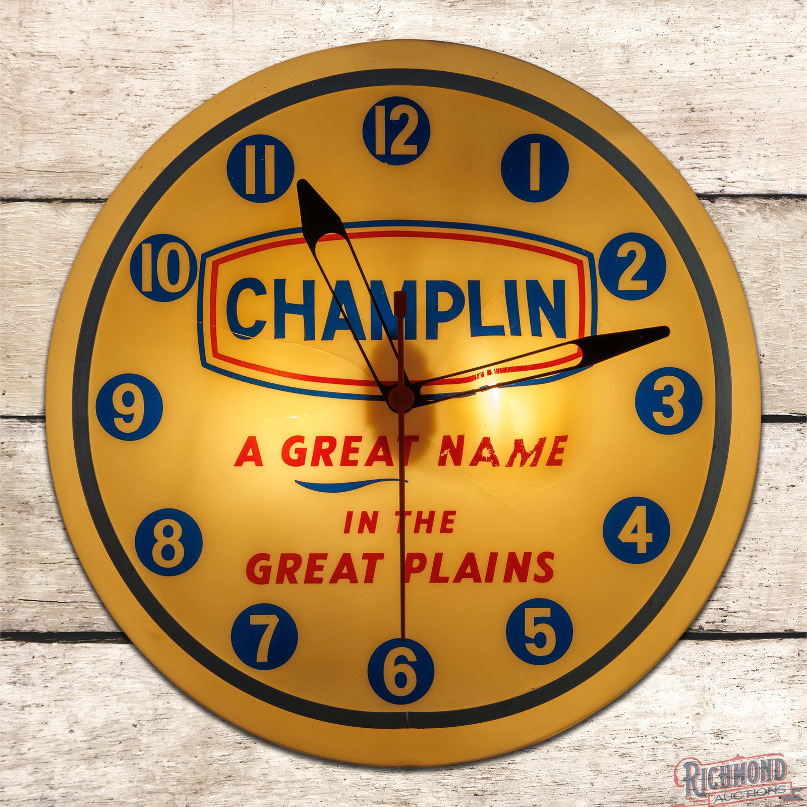 Champlin Oils "A Great Name in the Great Plains" 15.5" Dualite Lighted Advertising Clock w/ Logo: Lighted advertising clock works properly. The inner face has areas of toning with cracks and an area of indentation in the right field due to a high-wattage bulb. The perimeter is in very good conditi